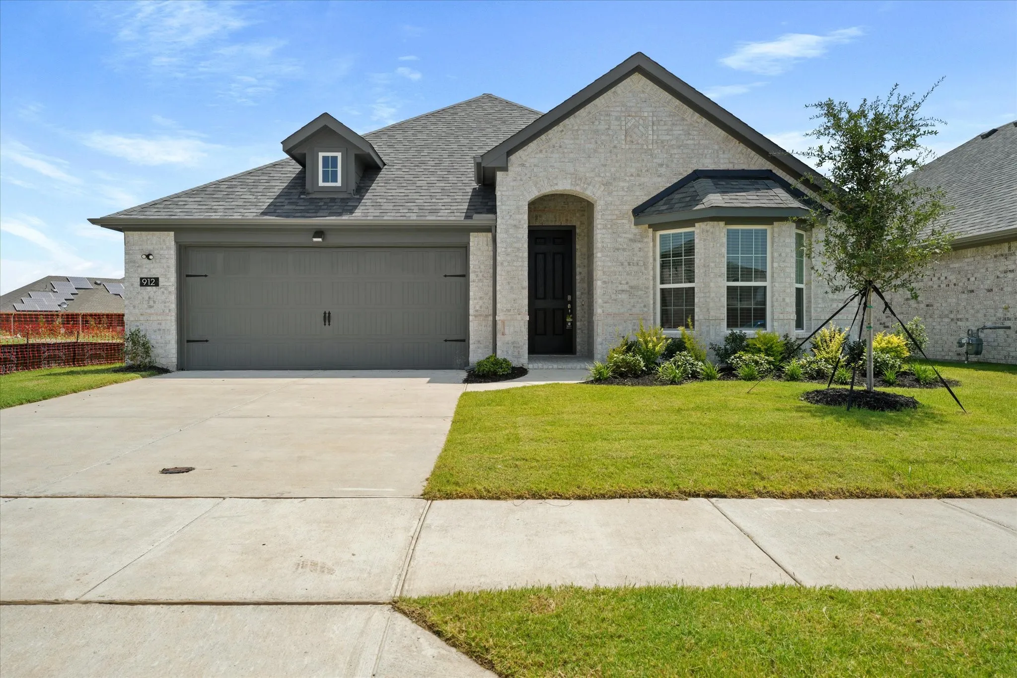 View of front of home featuring a garage and a front yard