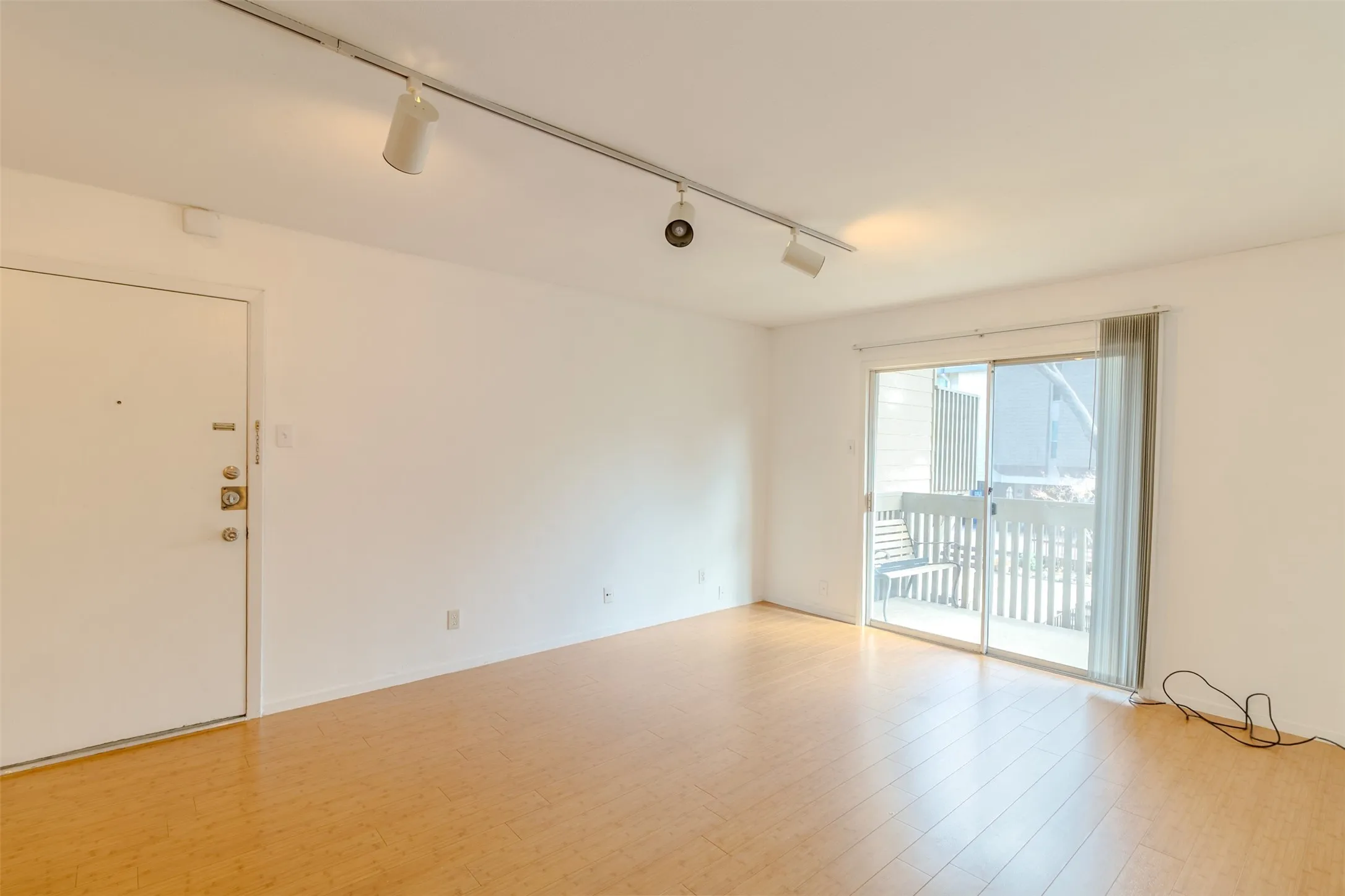 Spare room with track lighting and light wood finished floors
