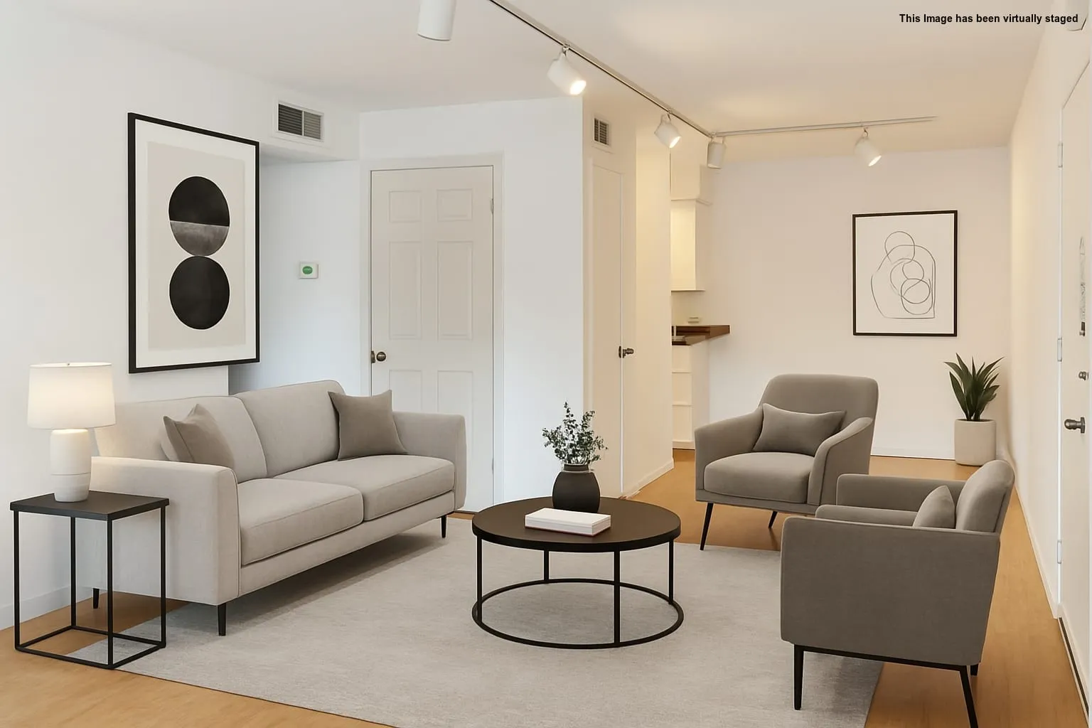 Living area with track lighting and light wood-style​​‌​​​​‌​​‌‌​‌‌​​​‌‌​‌​‌​‌​​​‌​​ flooring