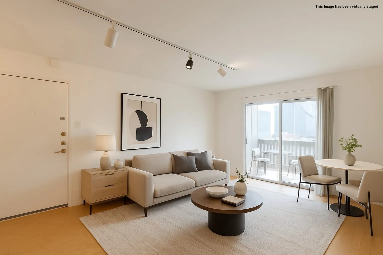 Living area featuring track lighting and light wood-style floors
