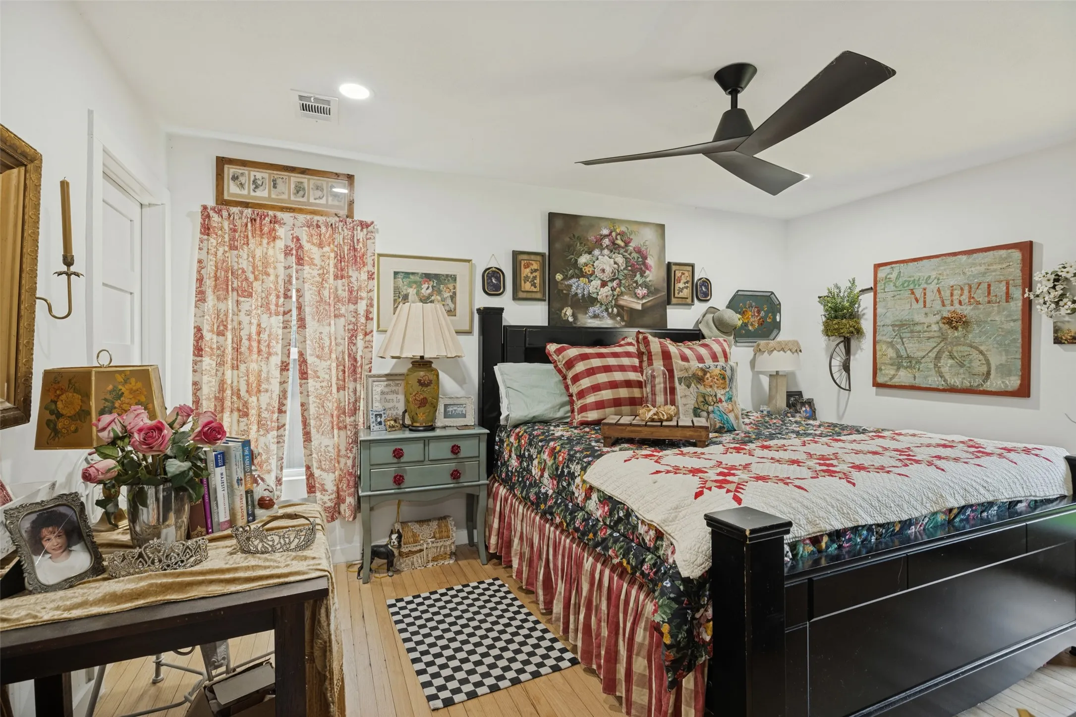 Wood-finish flooring, white walls, and a contemporary ceiling fan