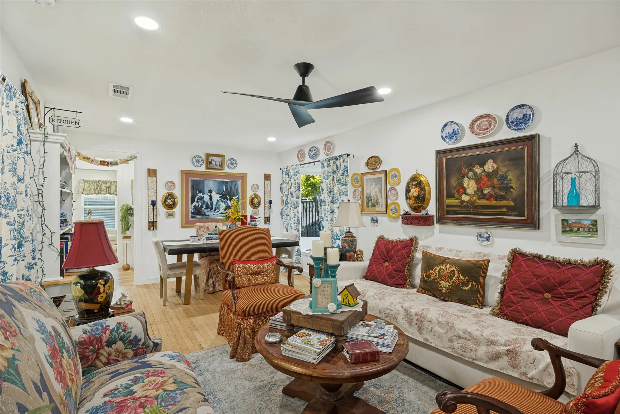 Hardwood flooring throughout, recessed lighting, and a contemporary ceiling fan