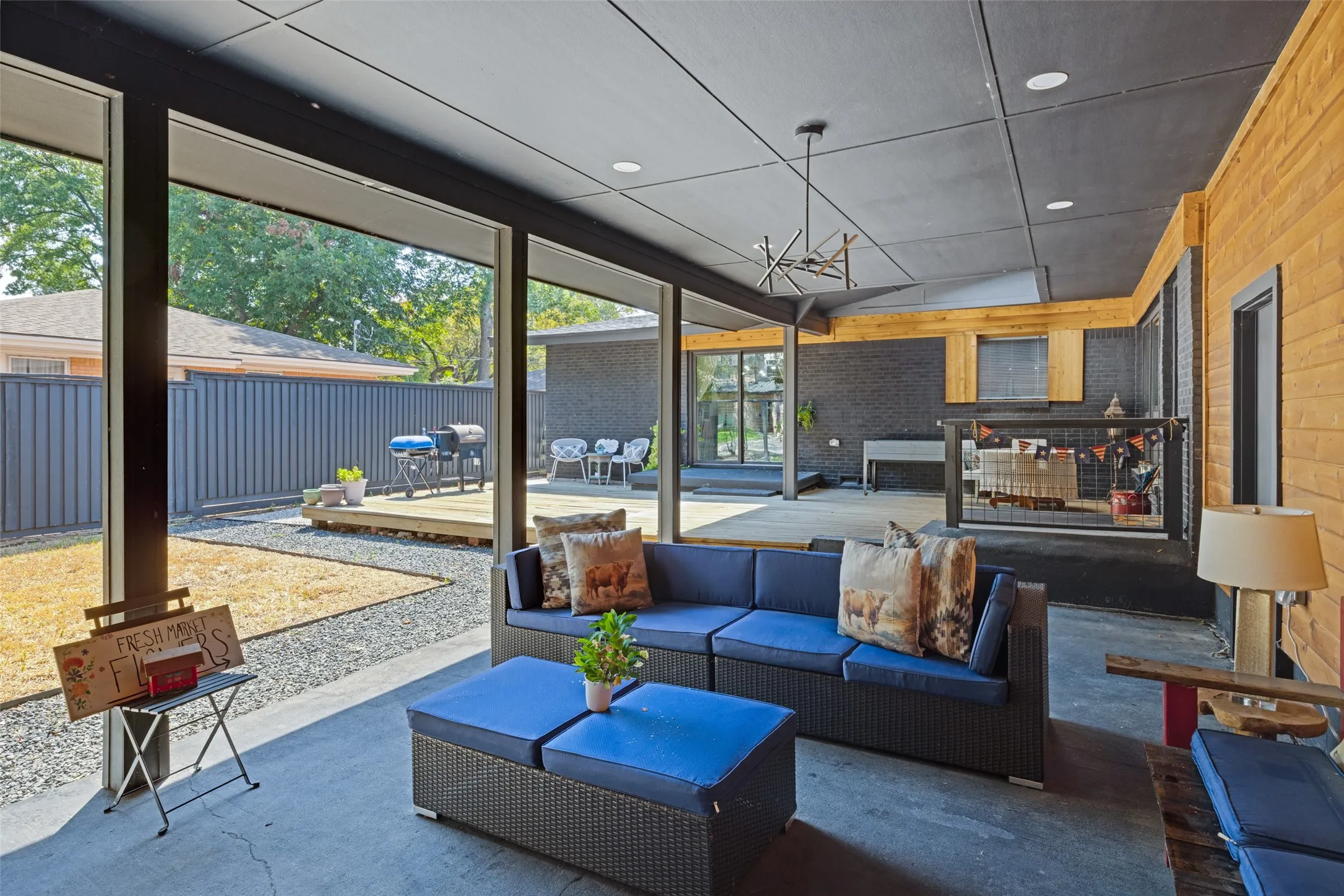 Expansive covered patio with recessed lighting and a contemporary chandelier