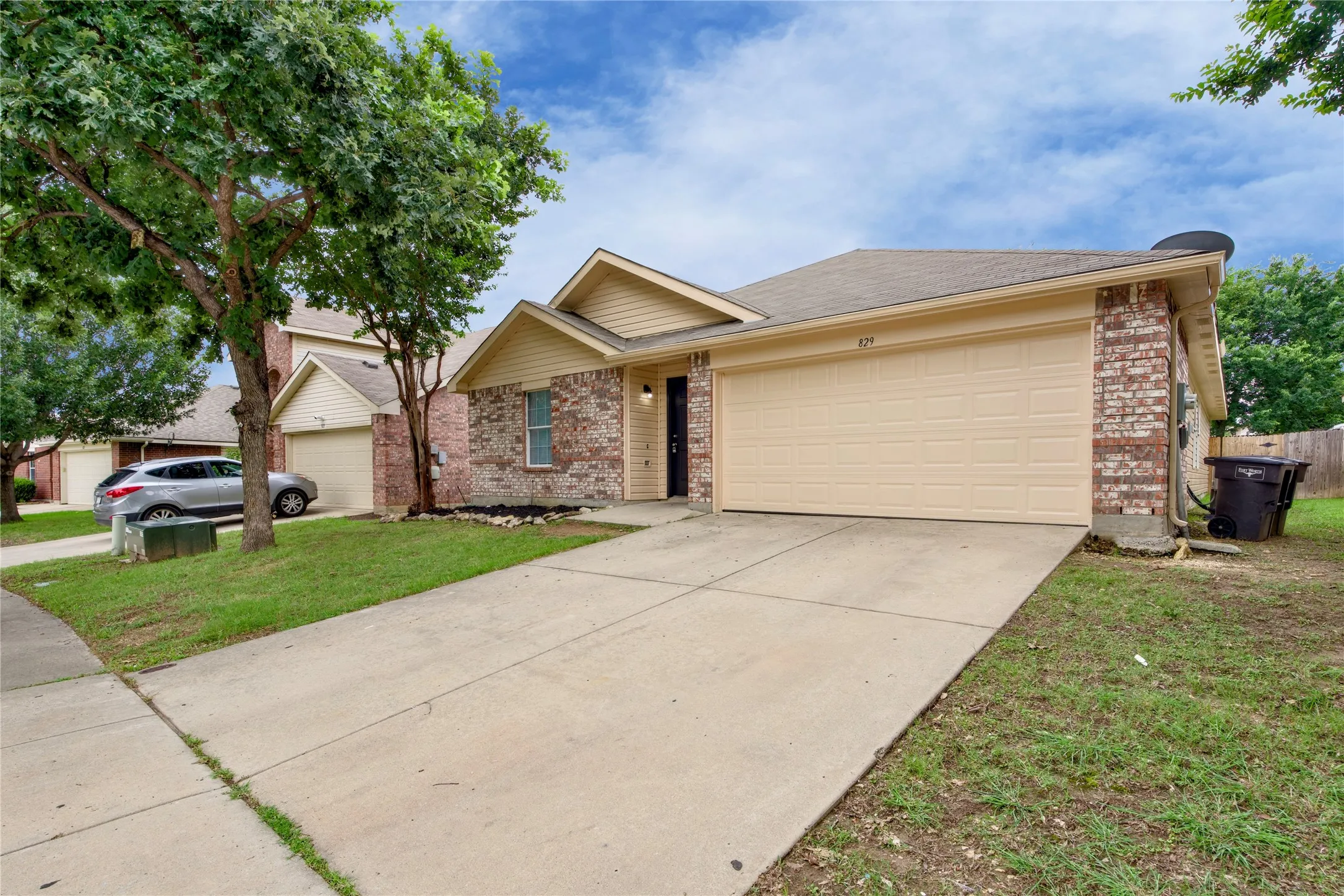 Brick and siding exterior with a single-car garage and concrete driveway