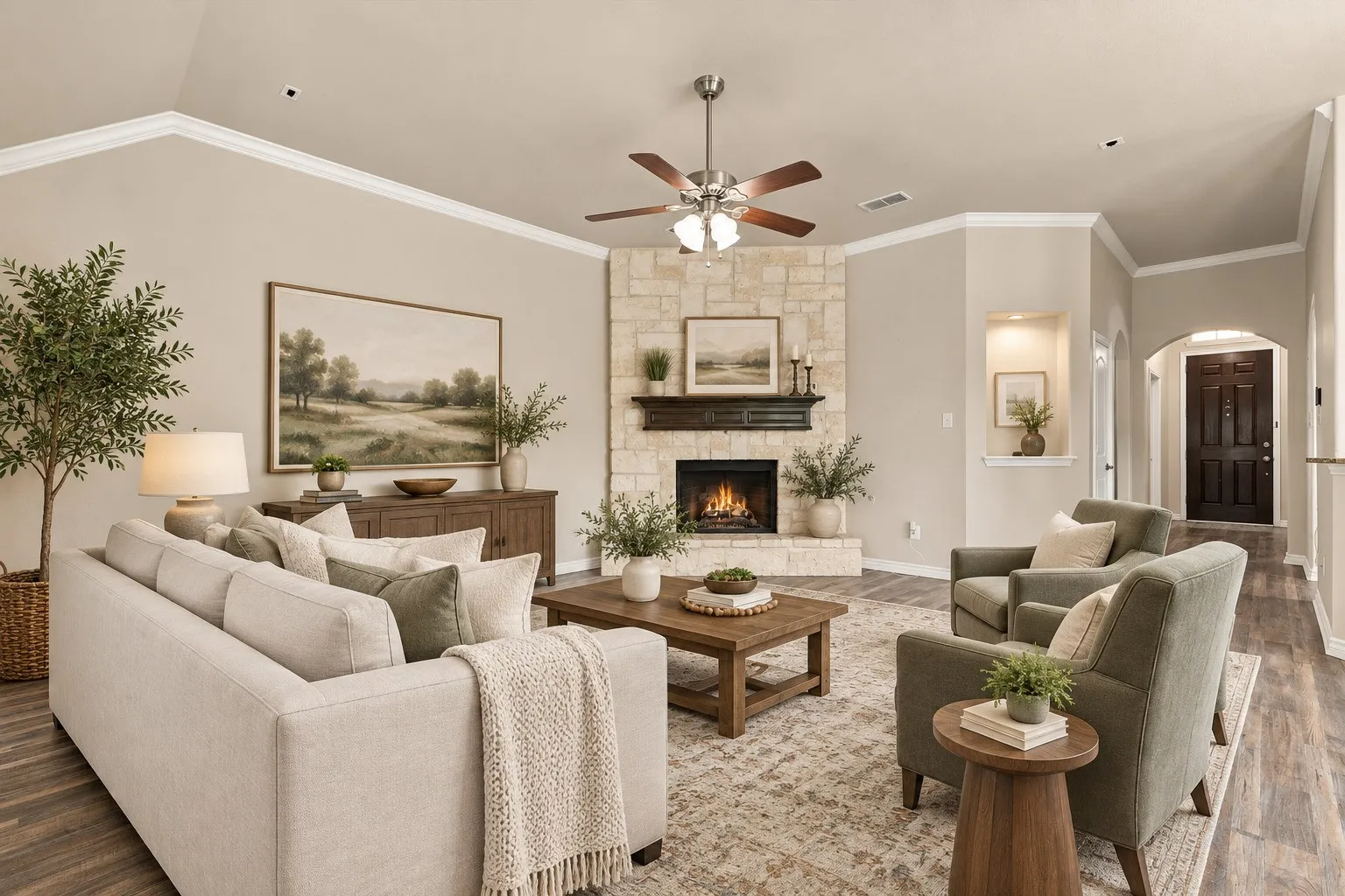Vaulted ceiling with crown molding, stone-clad fireplace with mantel, dark wood-finish flooring, recessed wall niche, and an arched entry