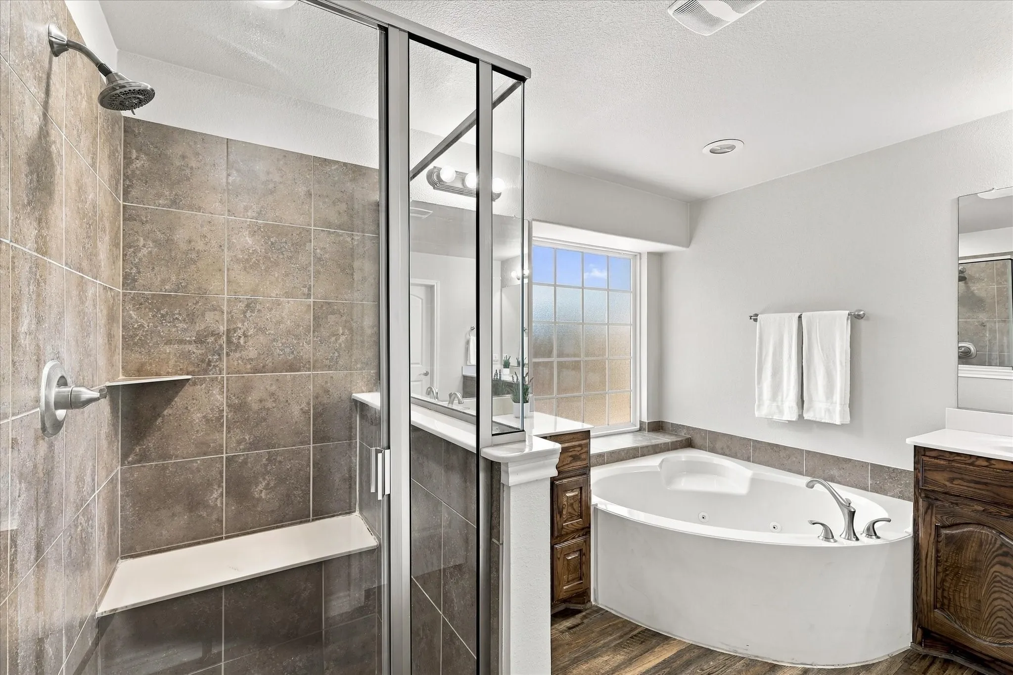 Walk-in shower with tiled walls and built-in bench