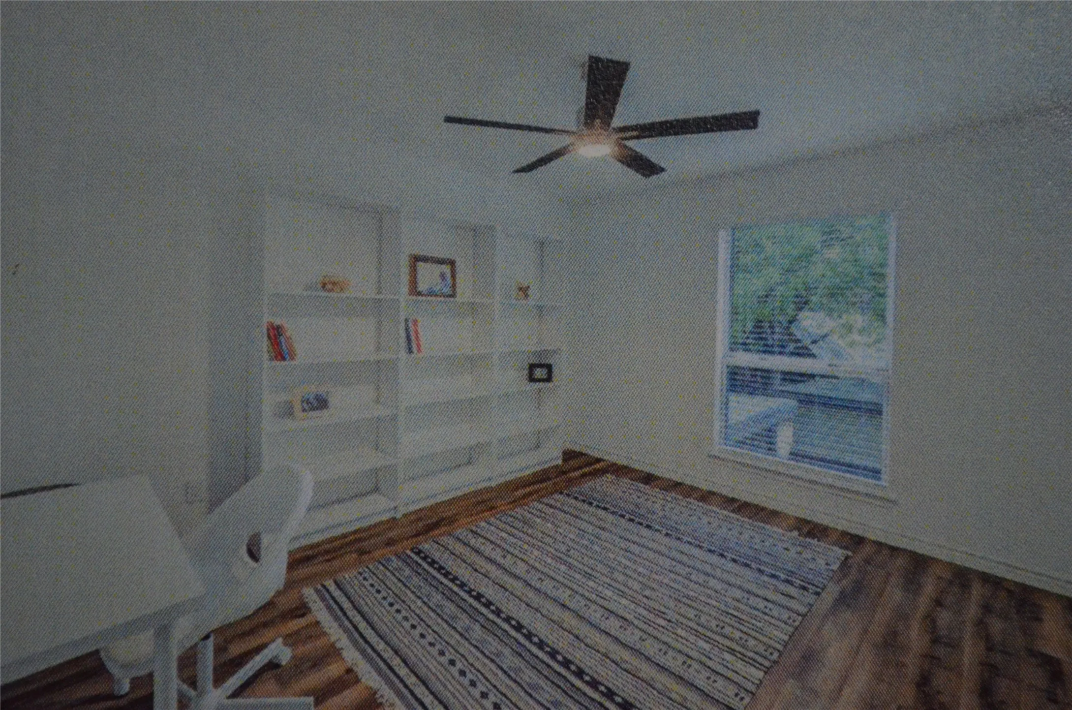Wood-finish flooring, built-in shelving, ceiling fan with integrated lighting, and a window with blinds