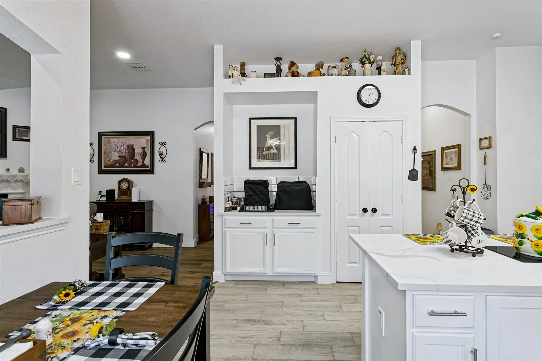 Kitchen island with a light-colored countertop and white cabinetry