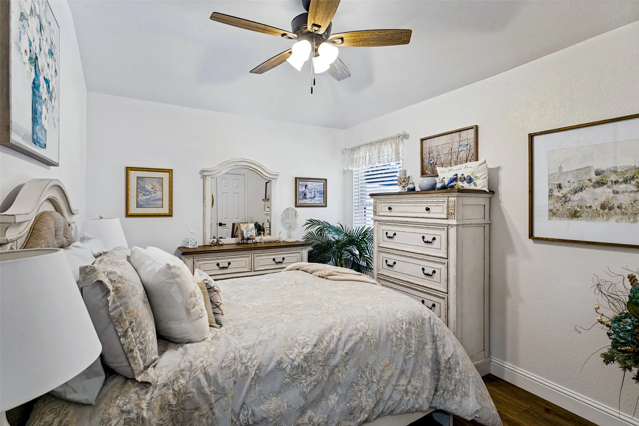 Vaulted white ceiling with a ceiling fan