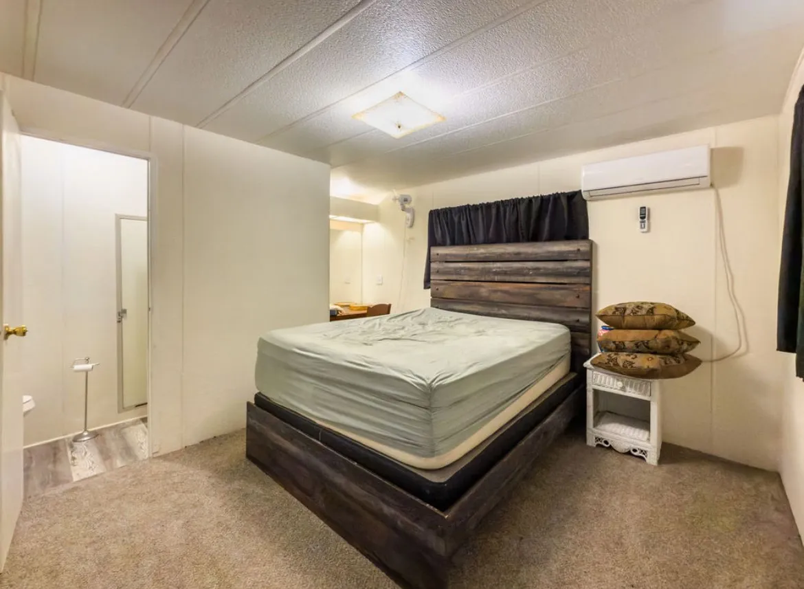 Carpeted flooring, built-in air conditioning unit, and a square ceiling light fixture