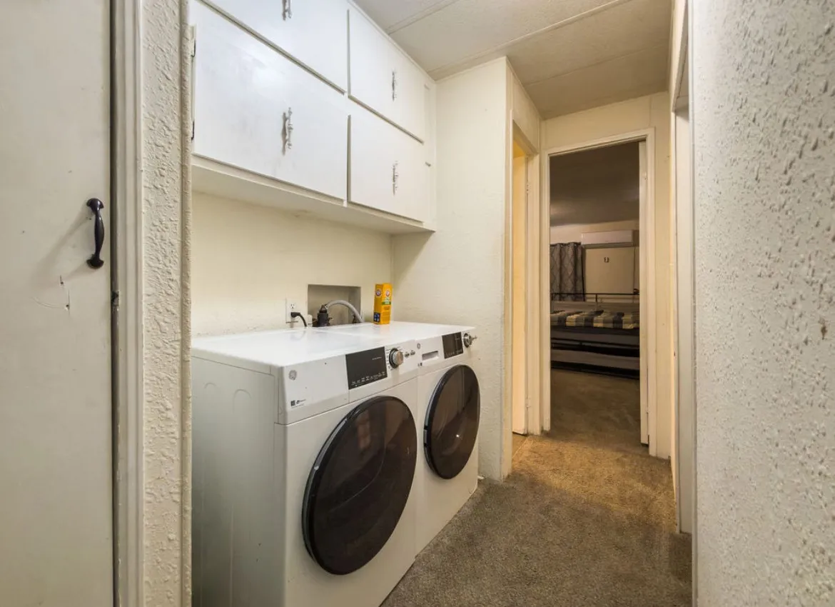 Laundry area with built-in overhead cabinetry