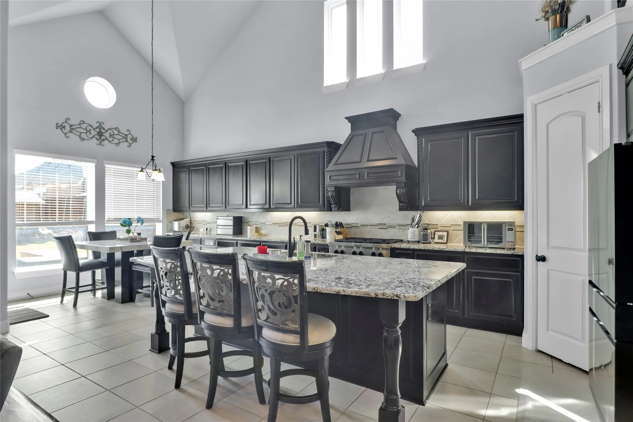 Kitchen with level breakfast bar and gas cooktop. Cabinets extend thru breakfast area for maximum prep space.