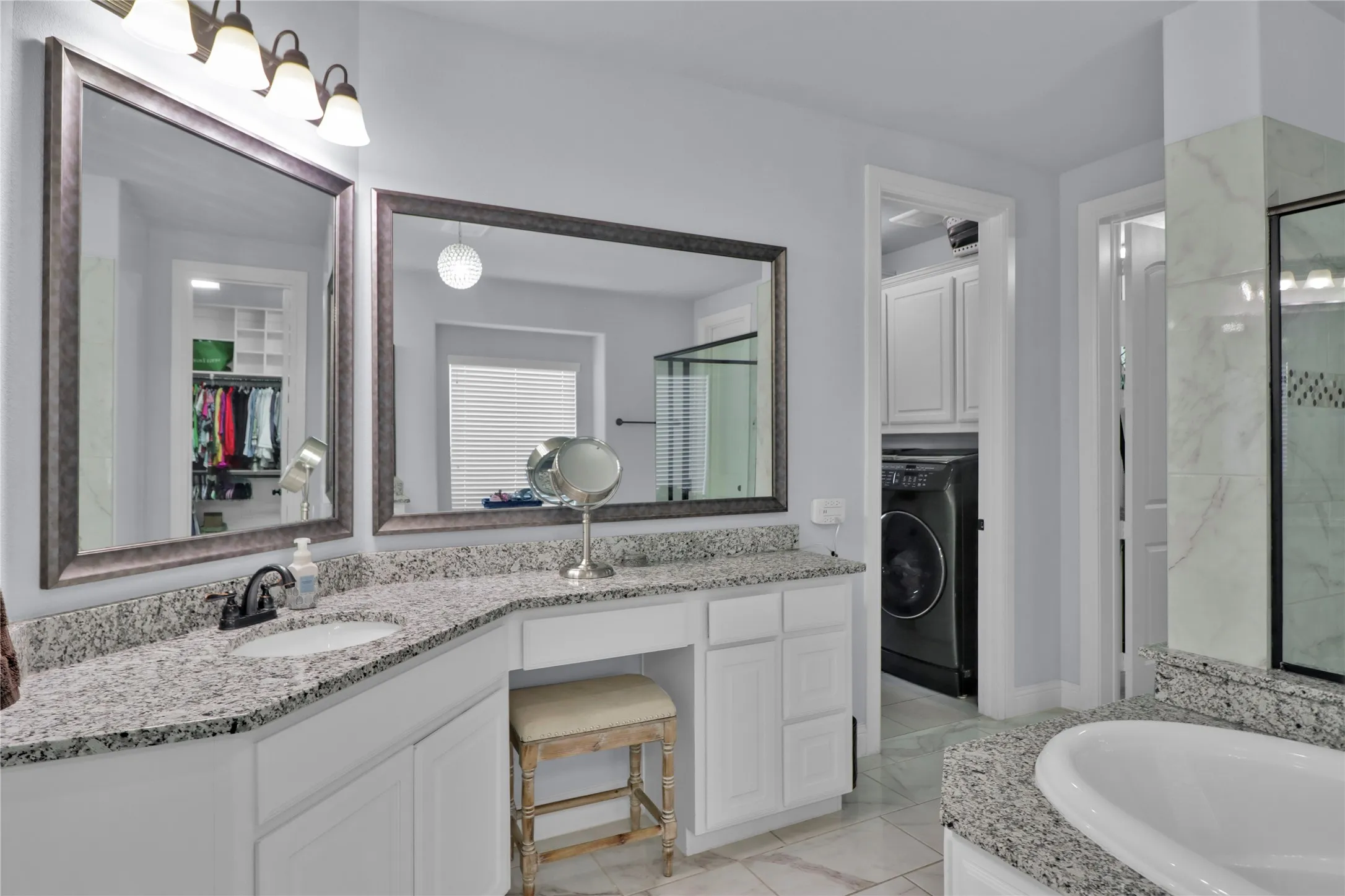 Separate vanities an access to laundry room.