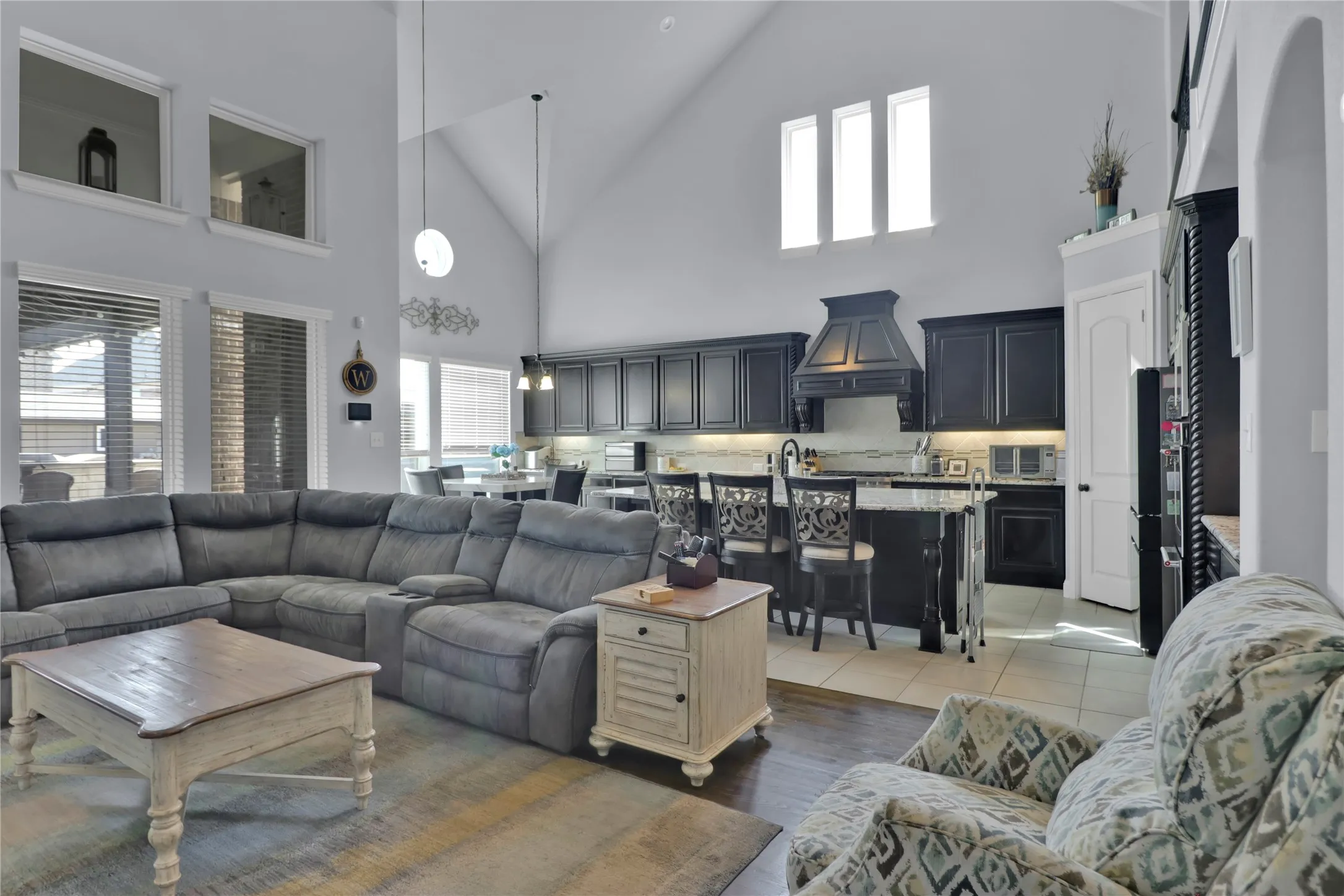 View of living room, kitchen and breakfast area overlooking the back yard. Notice the high ceilings.