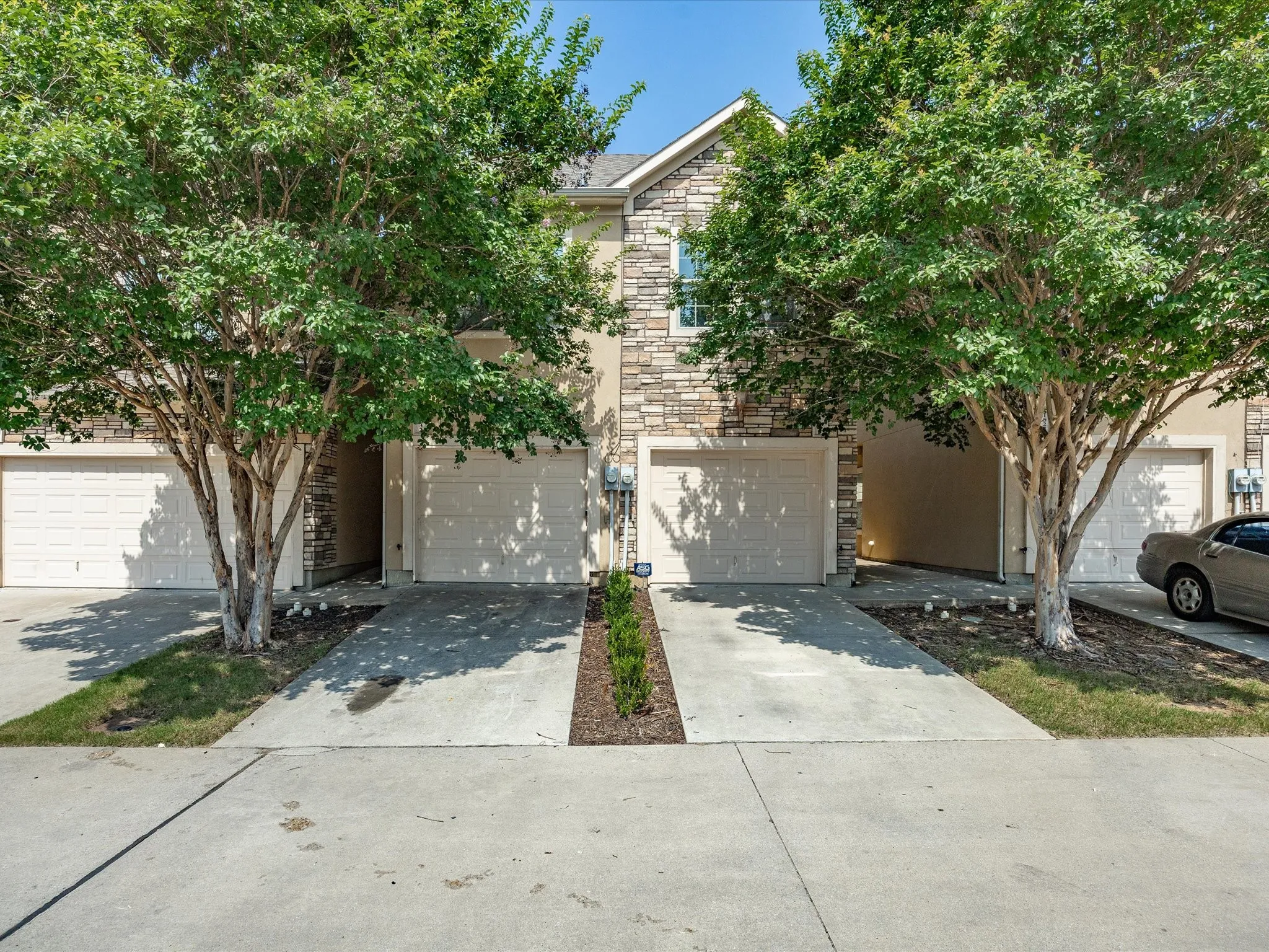 Stone and stucco exterior with multiple garage doors