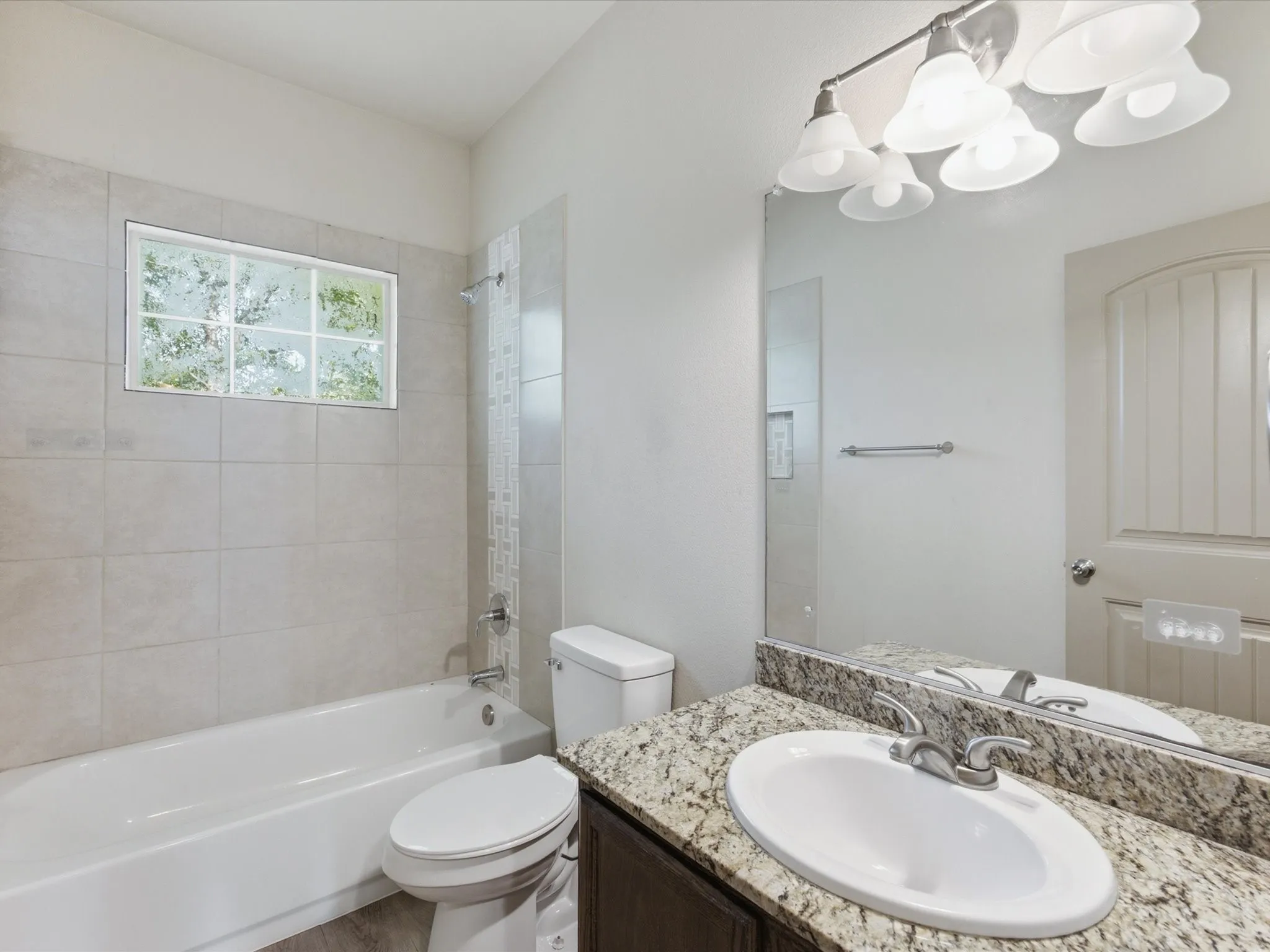 Tub/shower combination with tile surround, mosaic accent tile, and a privacy window