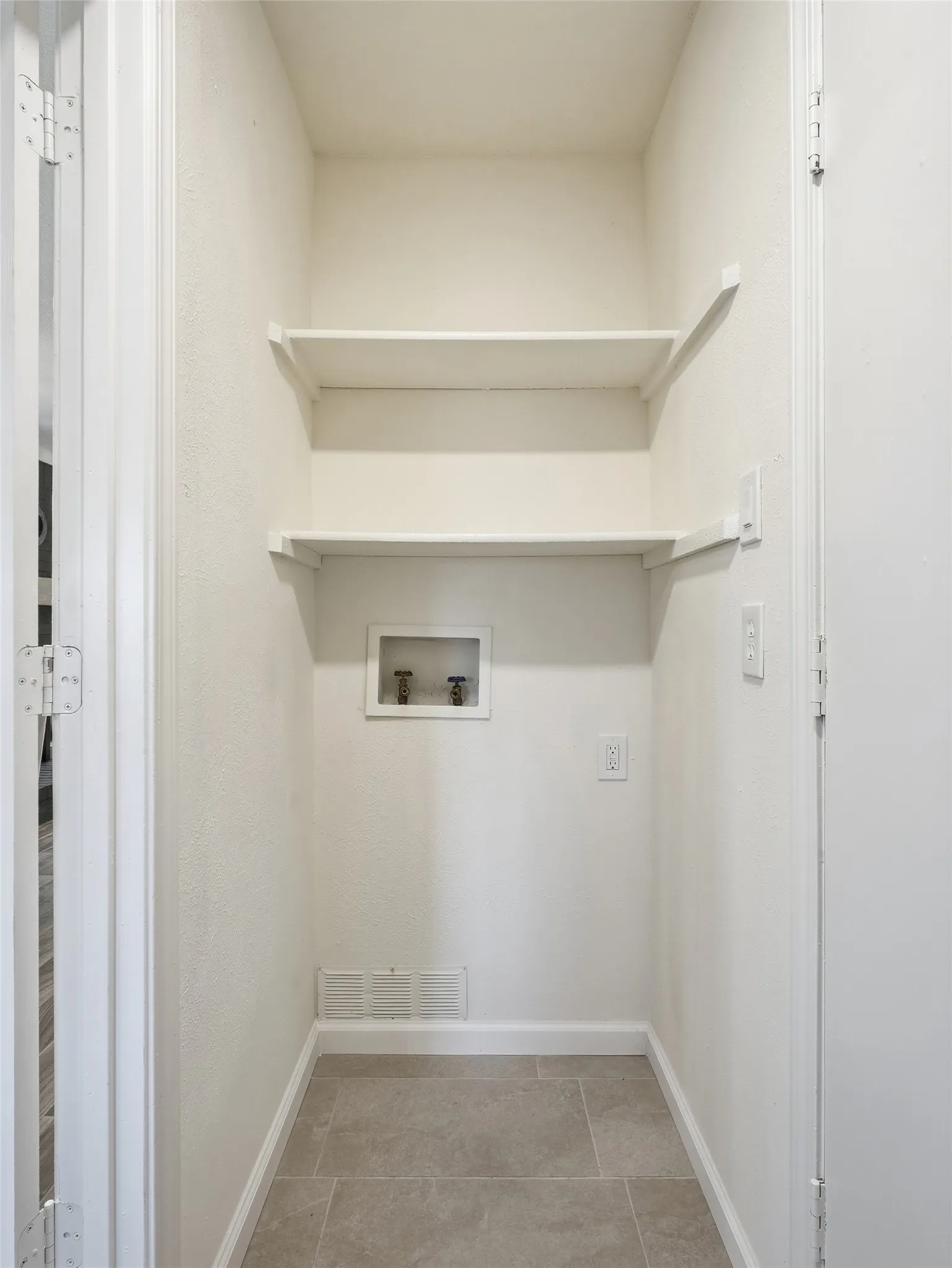 Utility closet with light beige wall paint