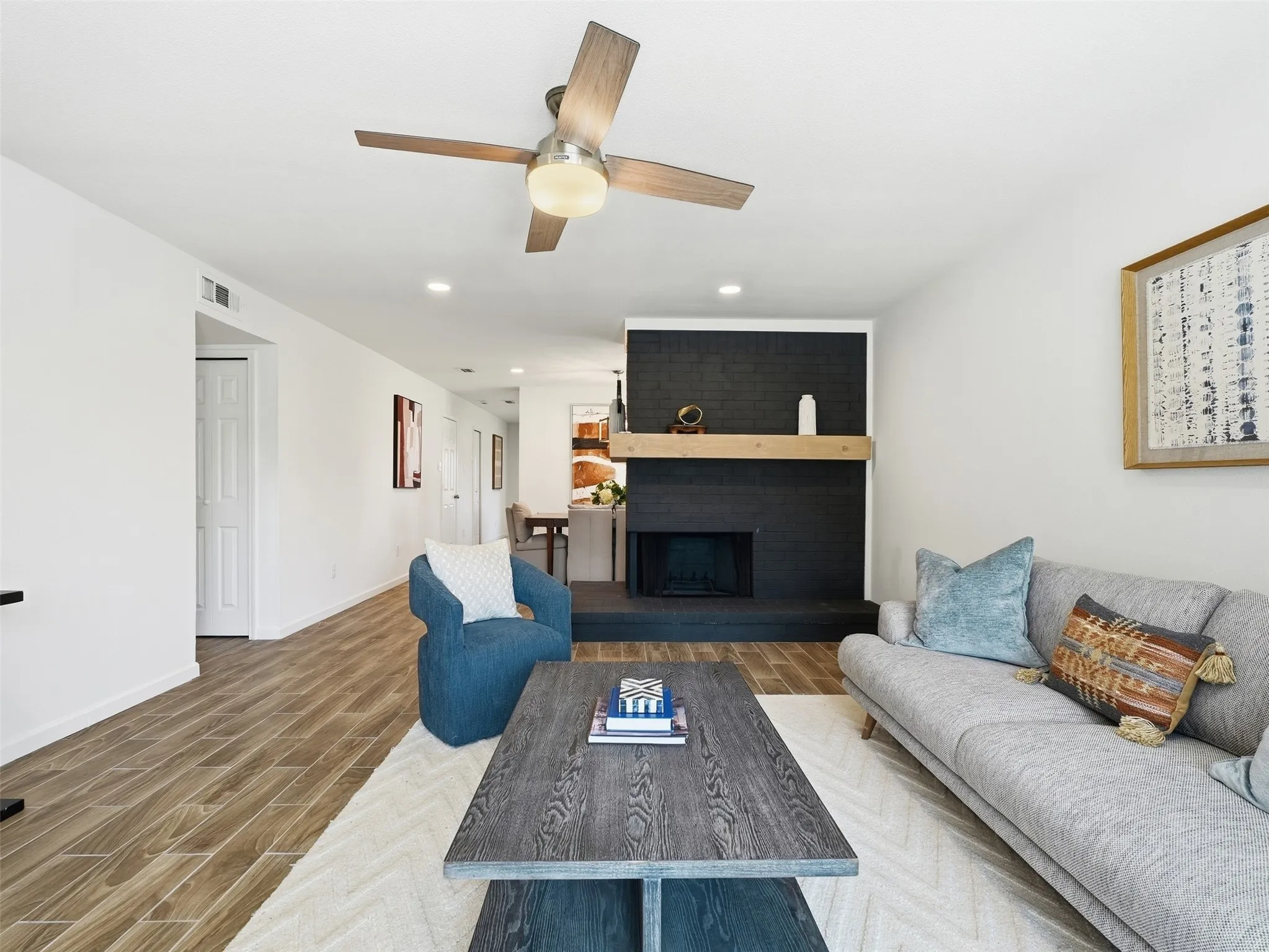 Wood-finish plank flooring, recessed lighting, and a modern ceiling fan with light fixture