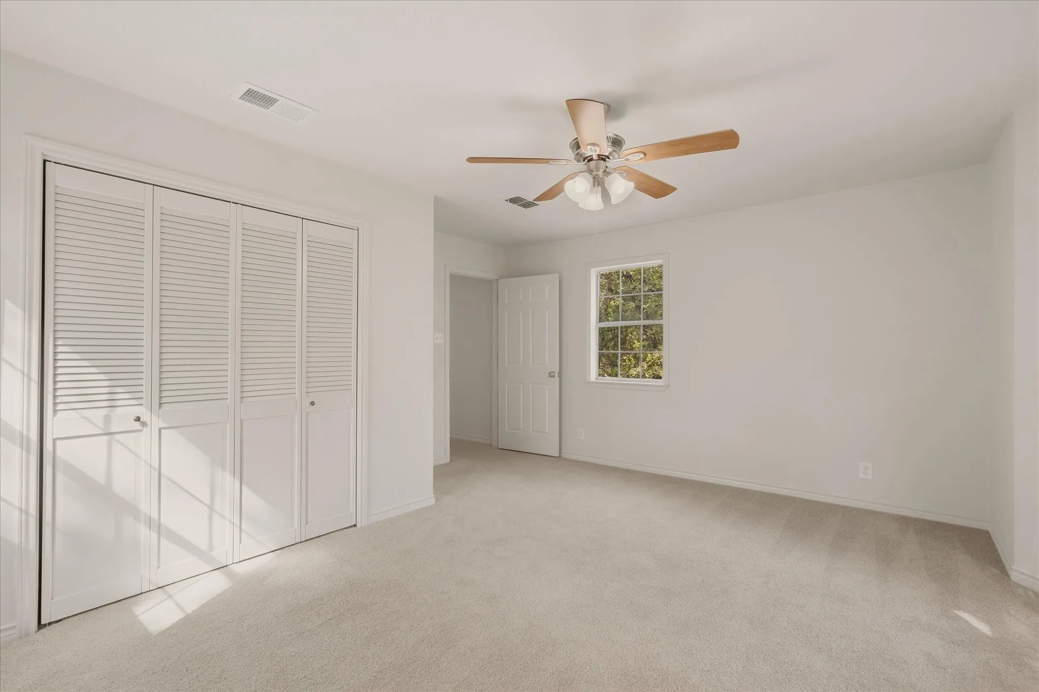 Primary bedroom with front-facing window.