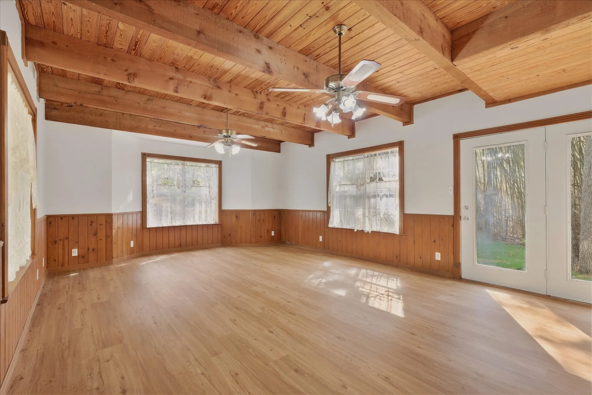 Cozy living room features lots of natural light and a beautiful, unique wood beam ceiling.