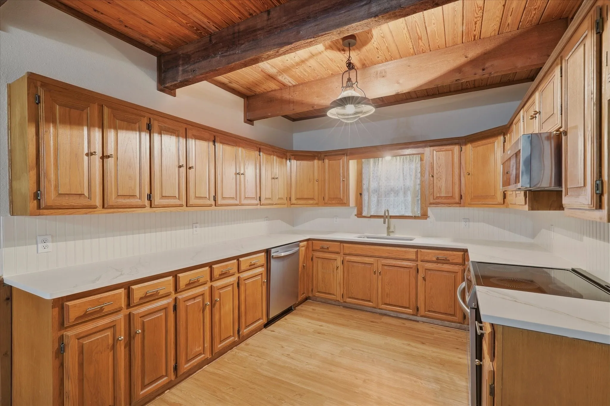 Brand new stainless steel appliances, farm sink, and quartz countertops.