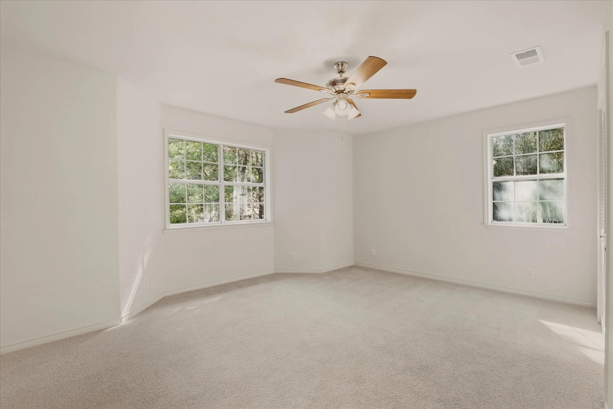 Primary bedroom upstairs - complete with views of front and back of property.