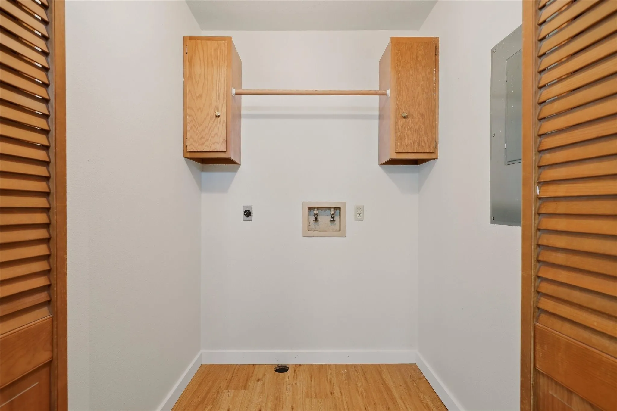 Laundry room with washer and electric dryer hookup.
