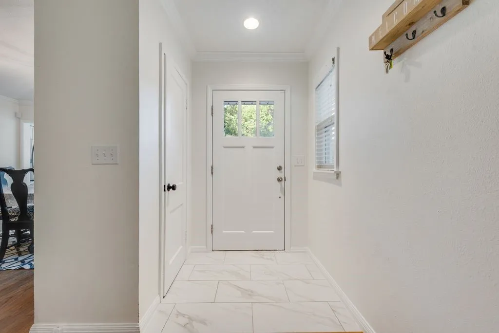 Step inside to a bright entry with marble look tile and a spot to hang your keys at the end of the day.