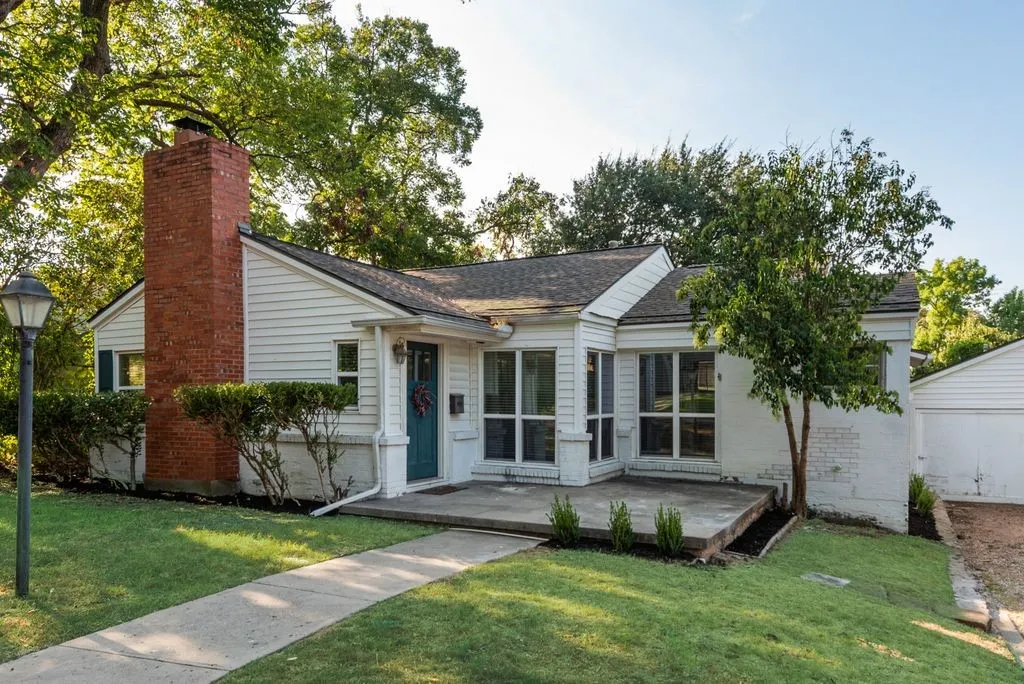 Classic brick chimney, crisp white siding, and shutters give this home timeless curb appeal. Set out a couple of chairs on the patio and spend your evenings greeting neighbors as they walk by.