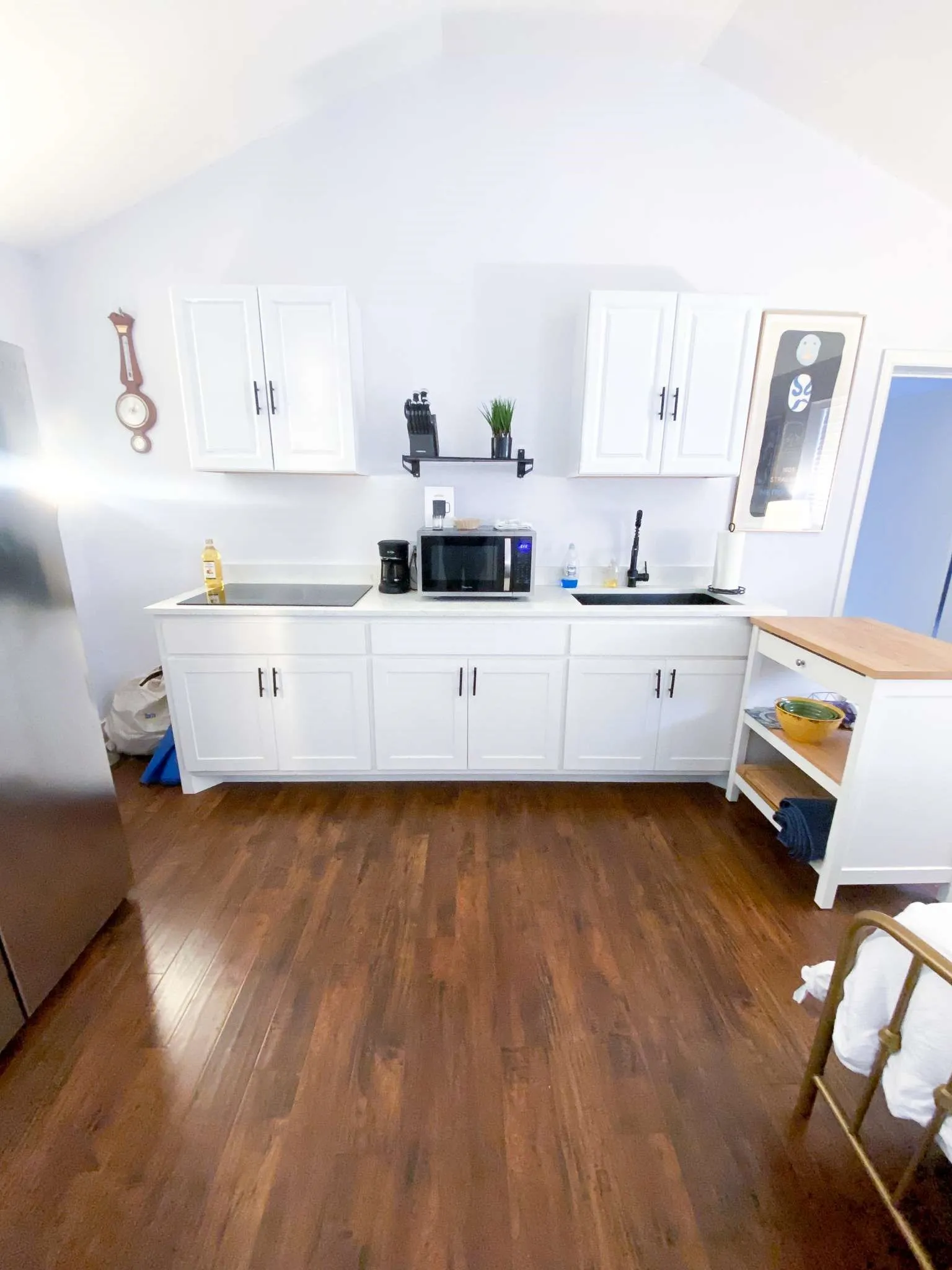 Whip up breakfast on the cooktop, brew your coffee, and wash up at the sink in this clean, modern kitchenette.