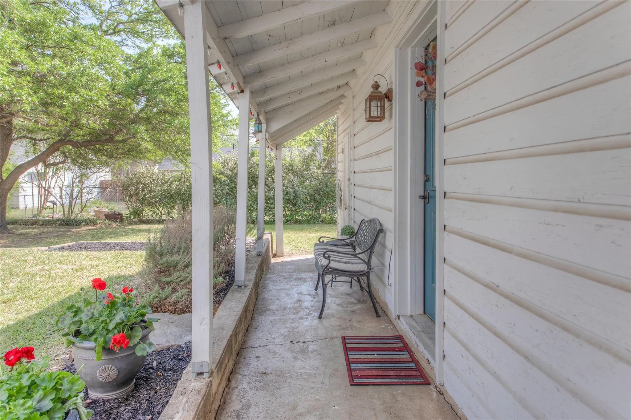 Unwind on the covered porch in the evening and take in the view of the wide green lawn and mature trees.