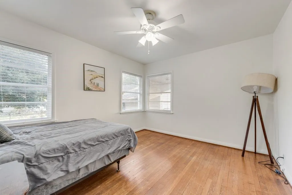 Corner windows fill this bedroom with sunshine, perfect for a child's room, guest room, or home office.