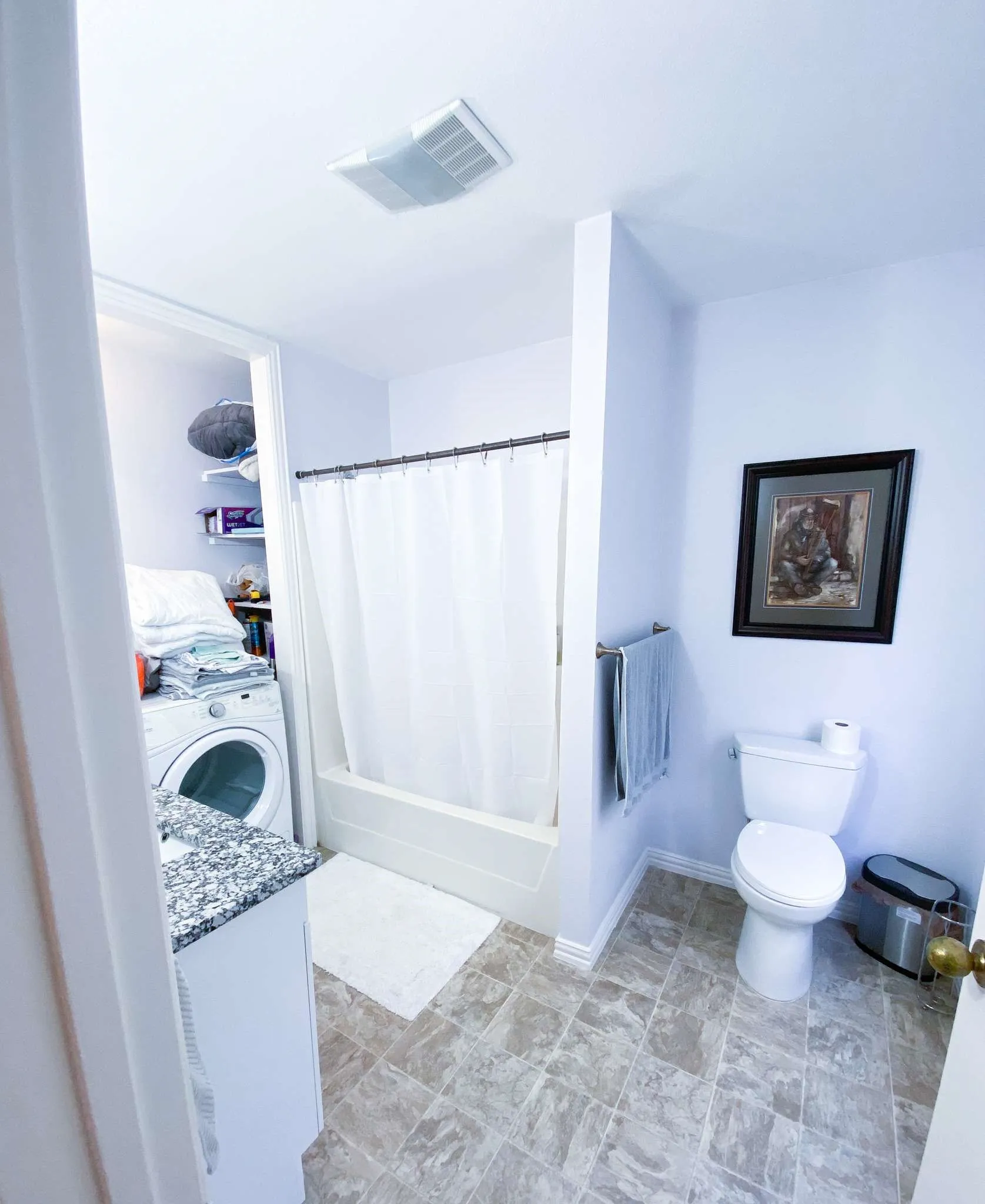 A full tub and shower, granite vanity, and extra shelving keep everything you need in one place.