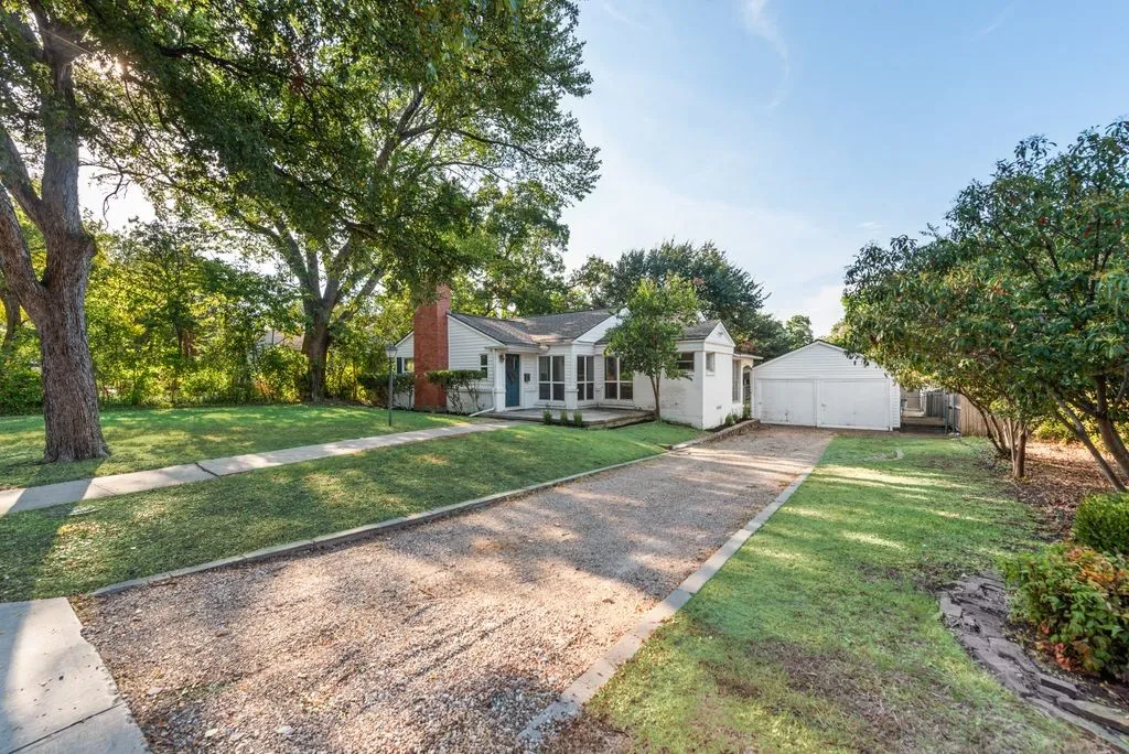 Pull into your own gravel drive under the shade of mature trees, with a charming guest suite set at the back of the lot.