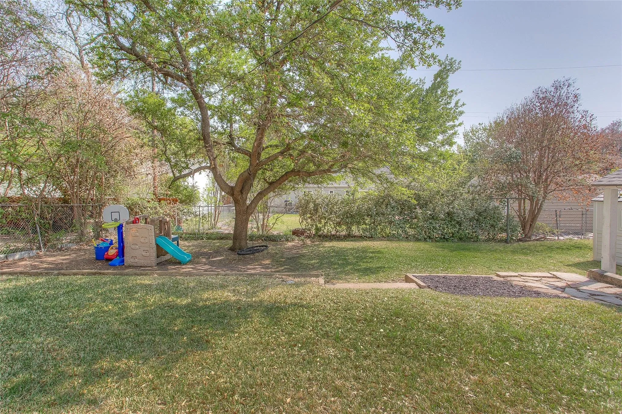 Watch the kids swing and slide under the big shade tree while you relax just steps away from the guest house.