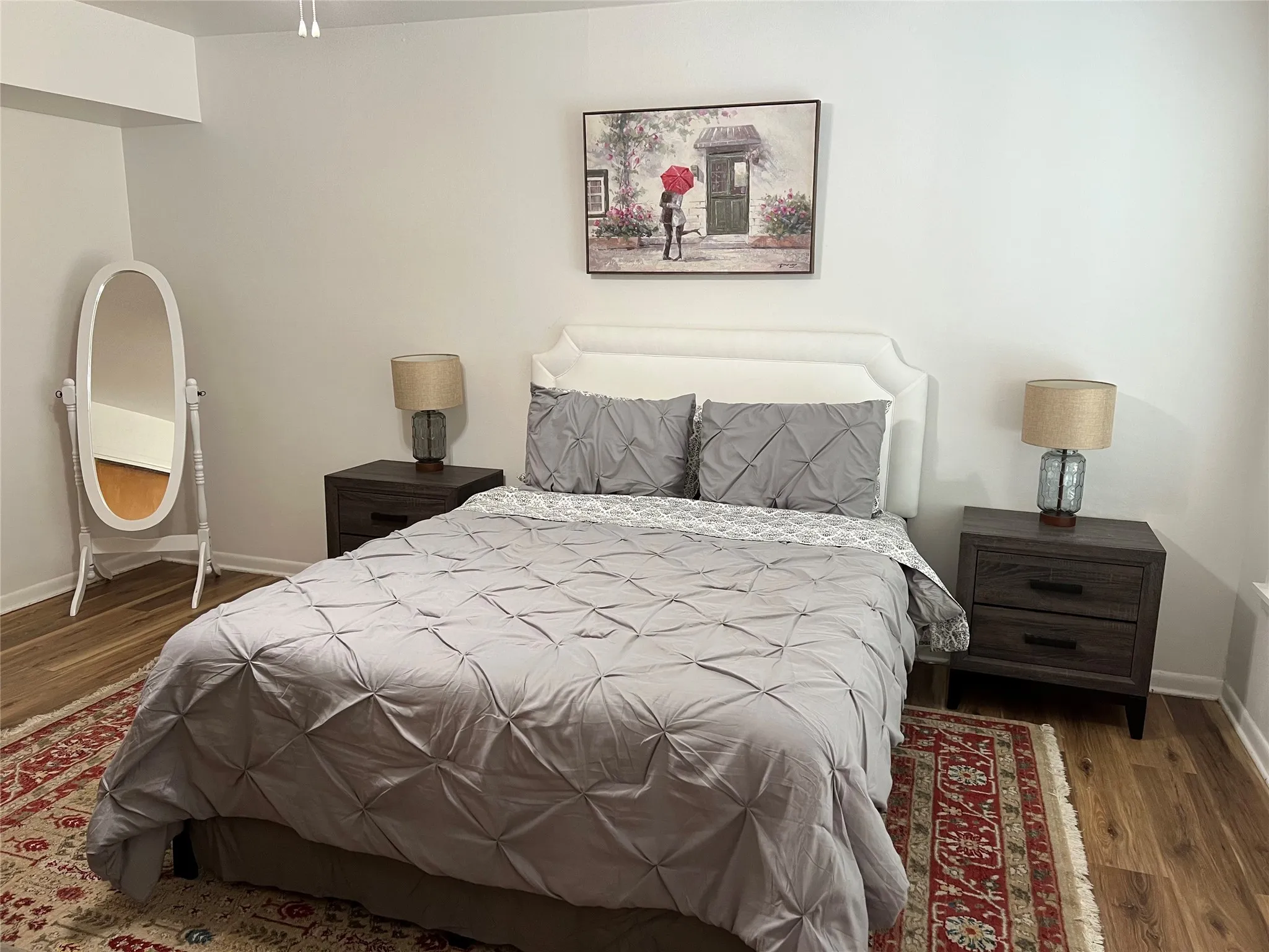 Bedroom 1 with ensuite bath and wood floors