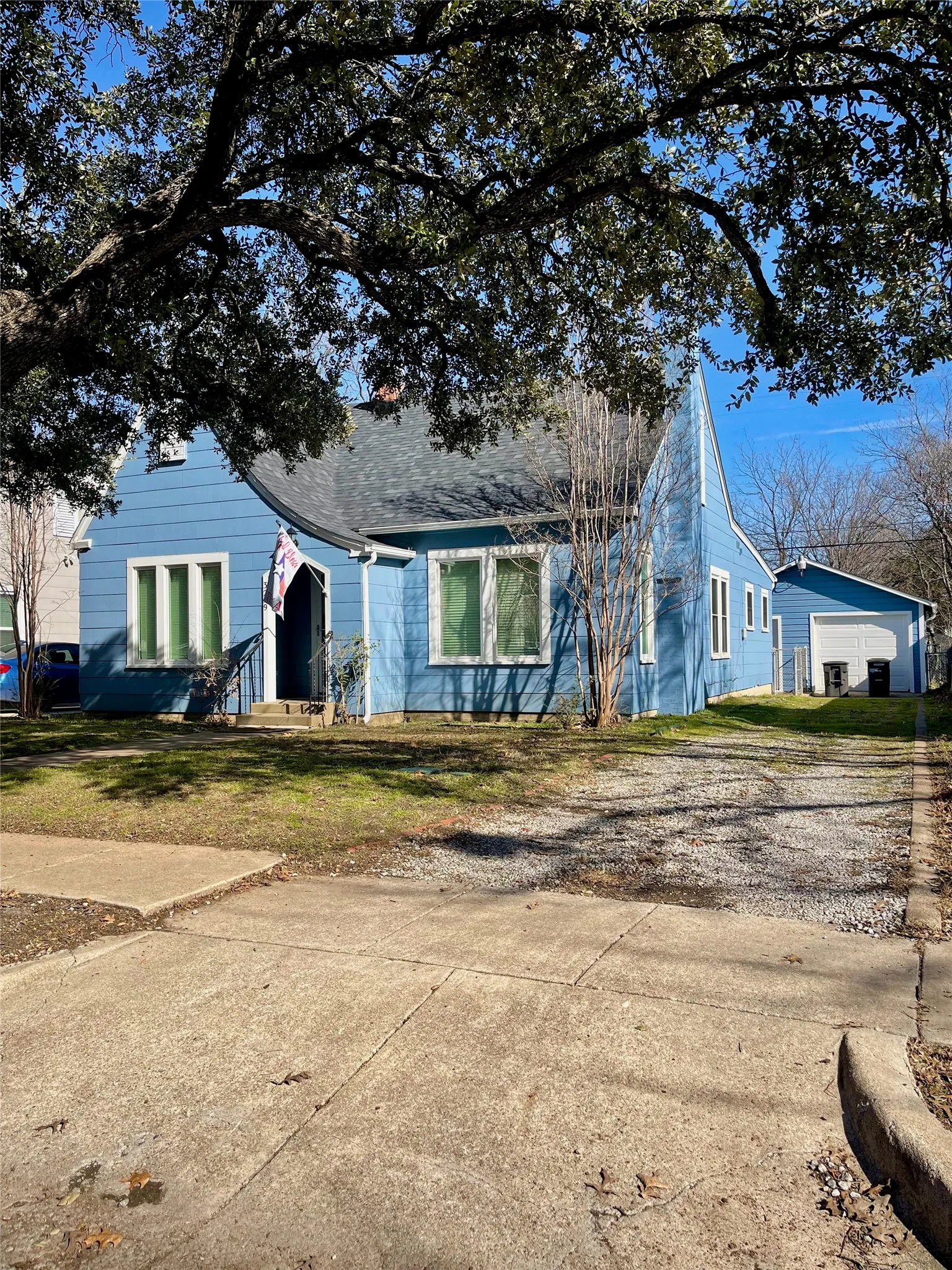 Bungalow-style home with an detached garage and long driveway