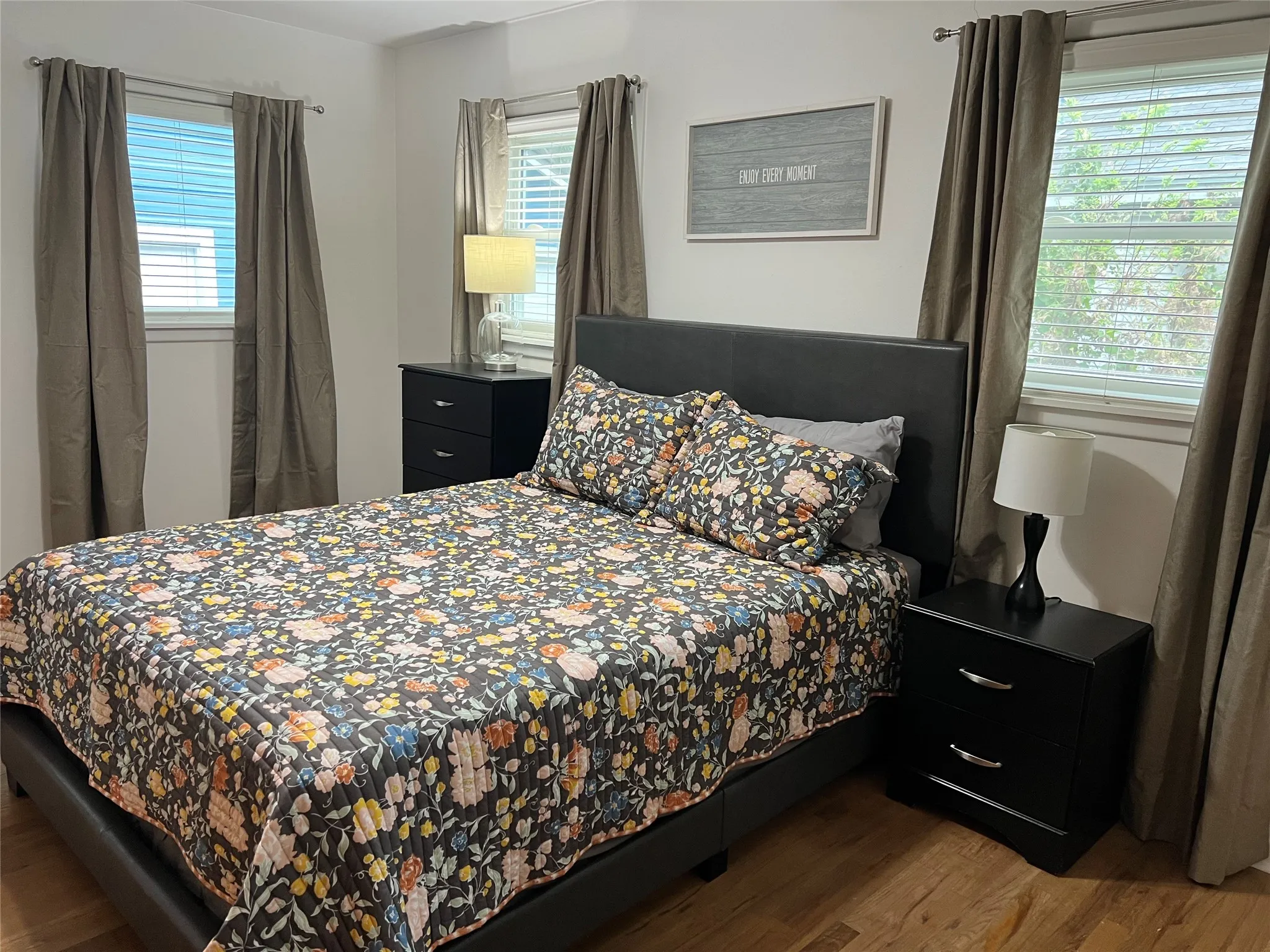Bedroom 3 featuring wood floors and natural light