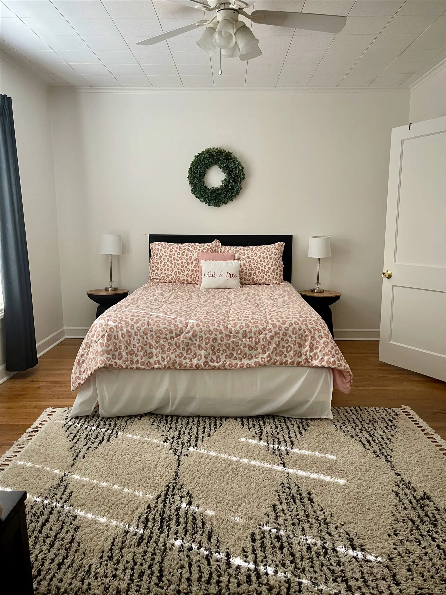 Bedroom featuring wood floors and ceiling fan