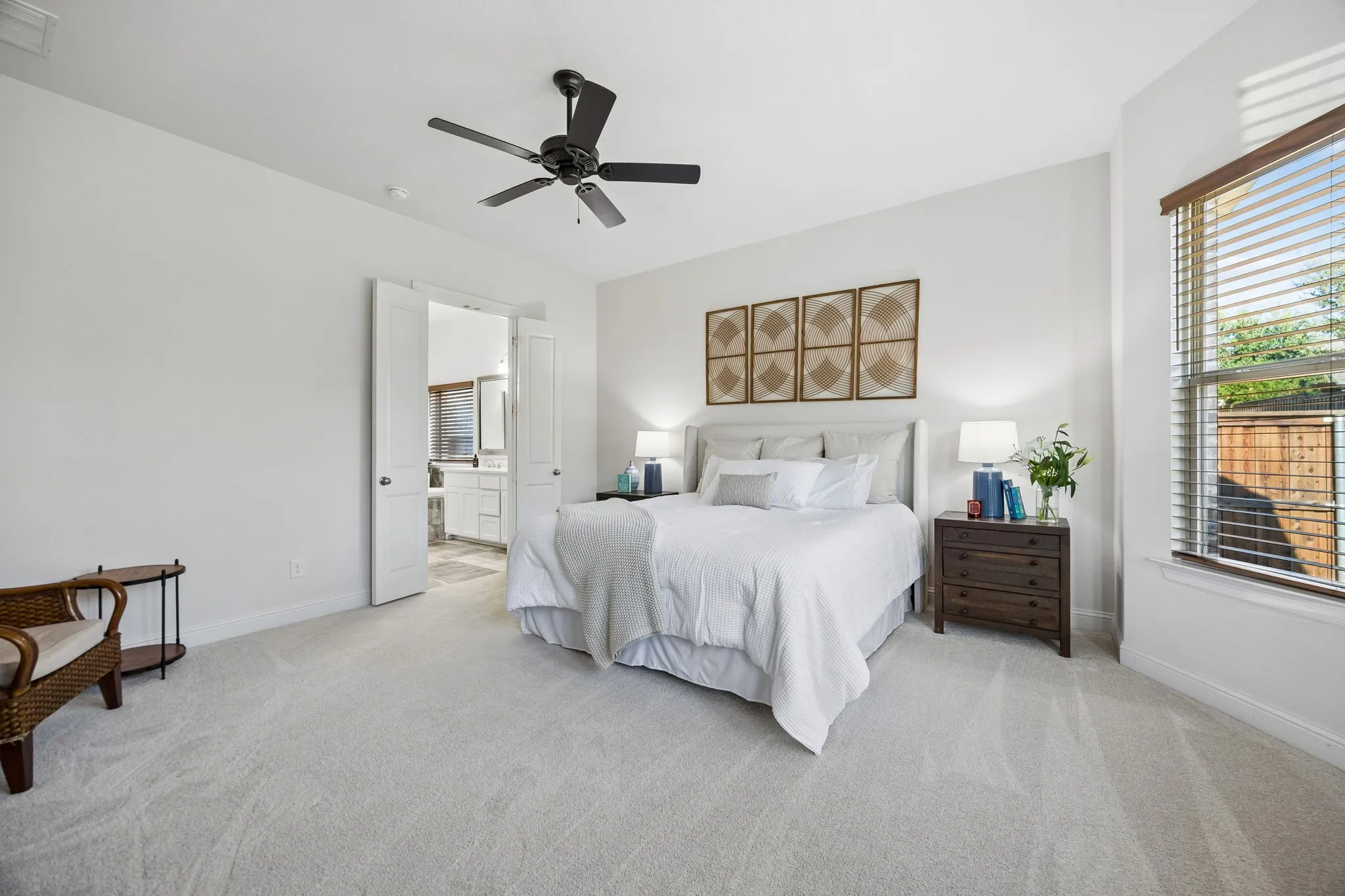 Primary Suite enjoys its own private setting at the rear corner of the house} with view of ensuite bath