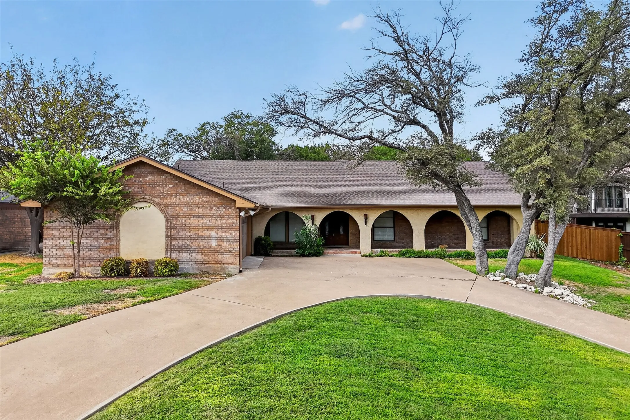Beautiful curb appeal with circle drive and archways on the huge front porch