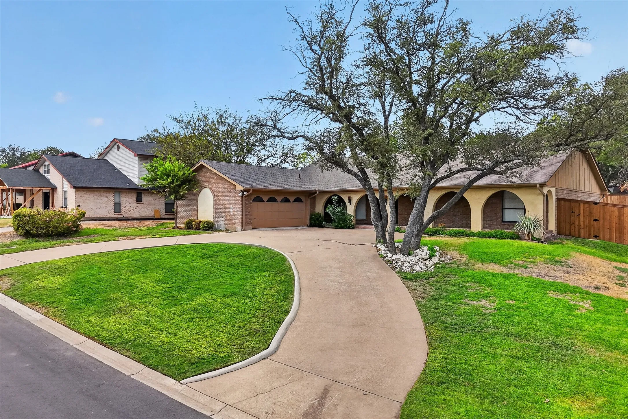 Beautiful curb appeal with circle drive and archways on the huge front porch