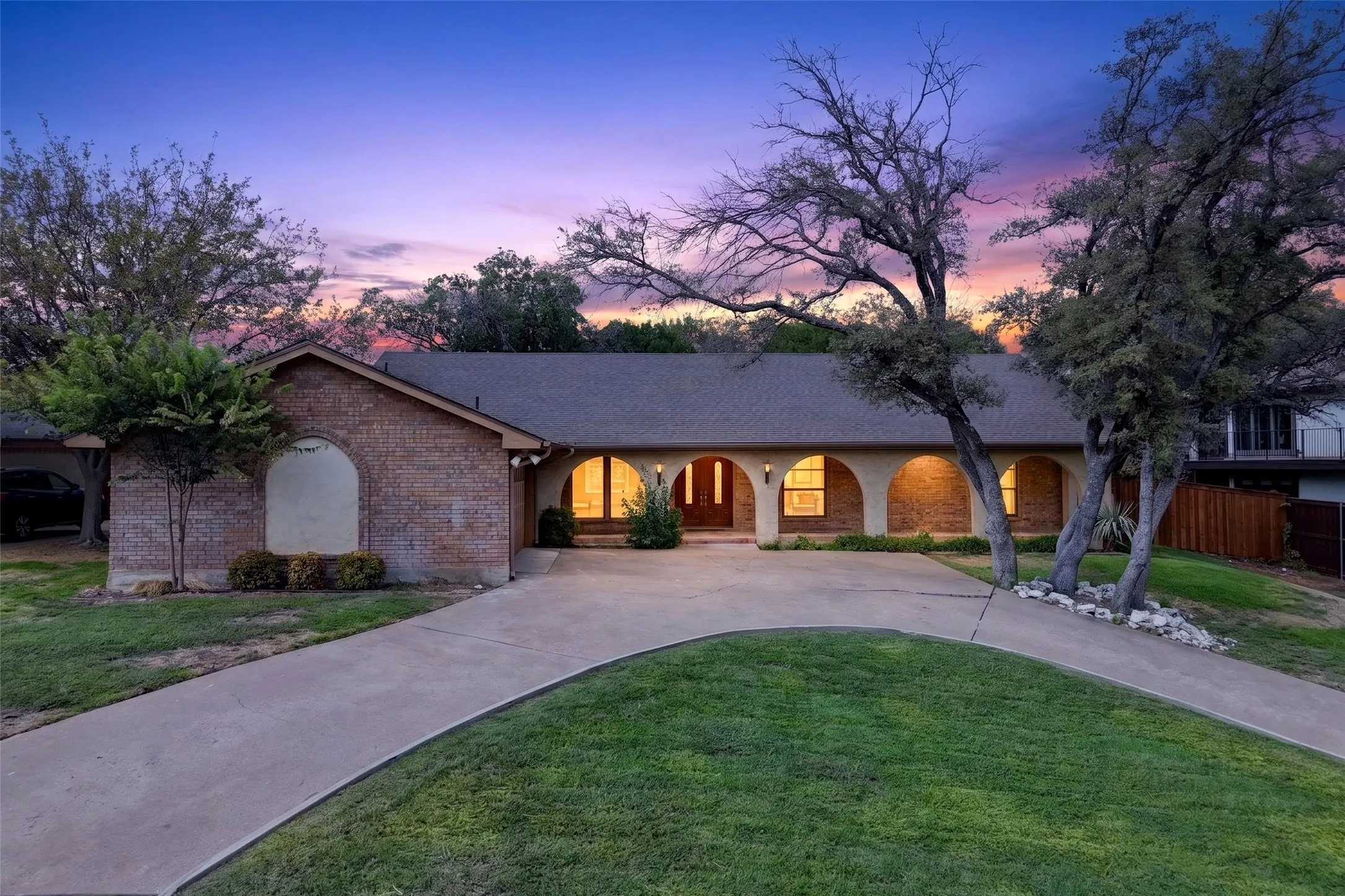 Beautiful curb appeal with circle drive and archways on the huge front porch