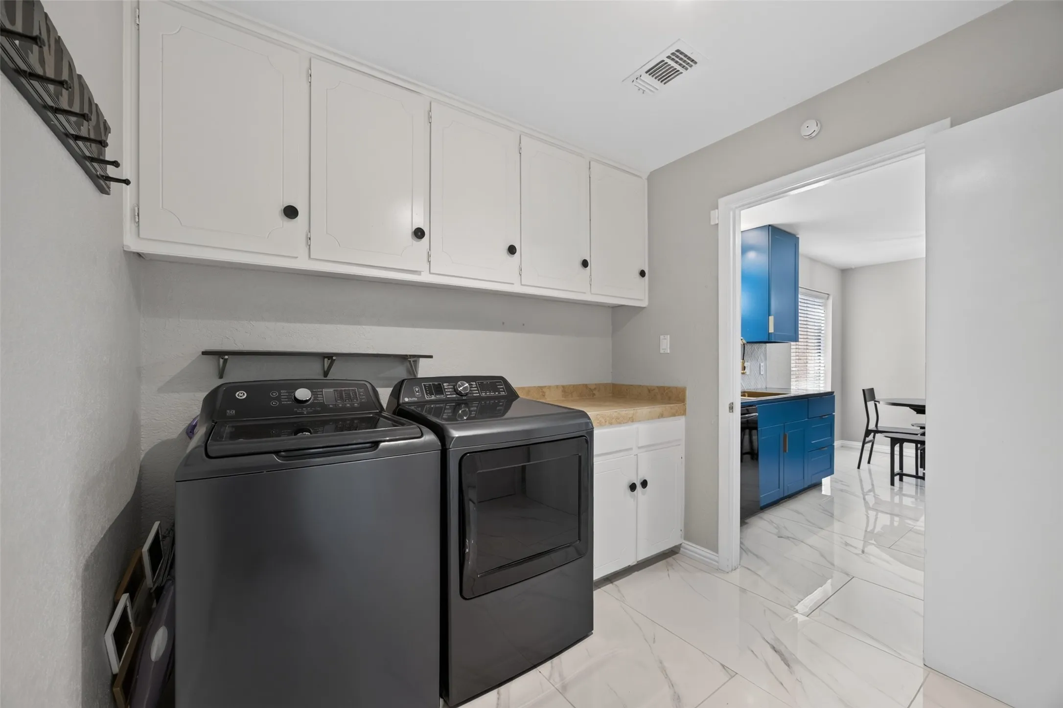 Large laundry room off the kitchen with lots of cabinets