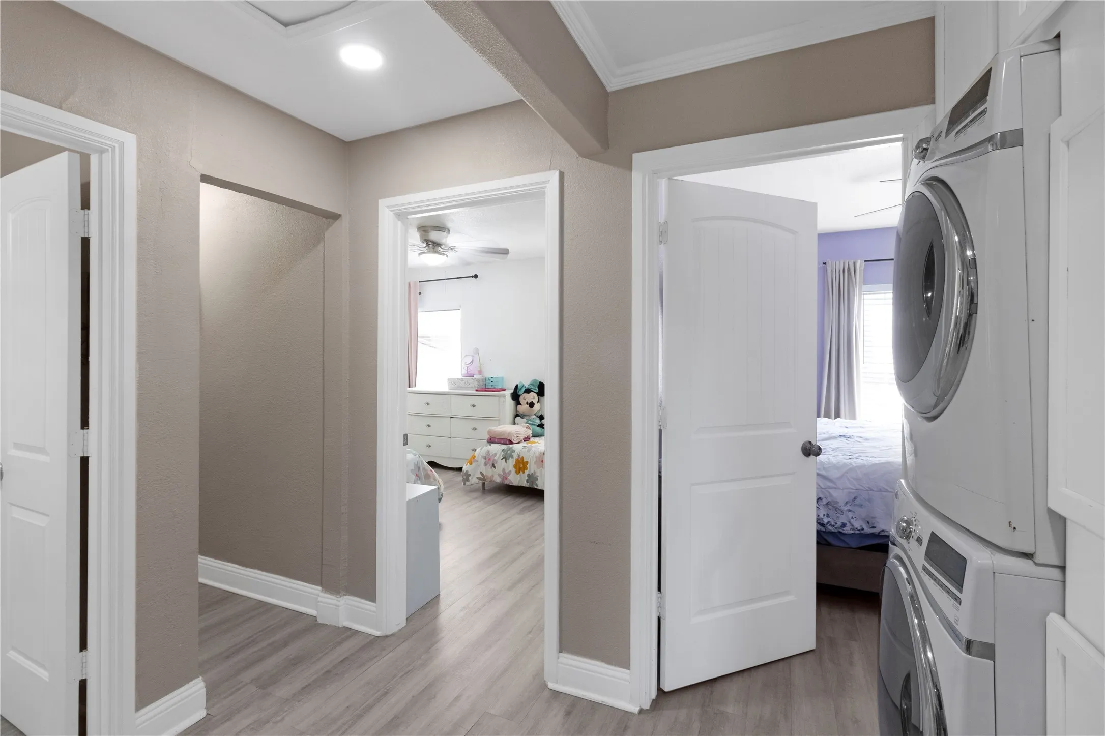 Recessed lighting, wood-finish flooring, and white trim