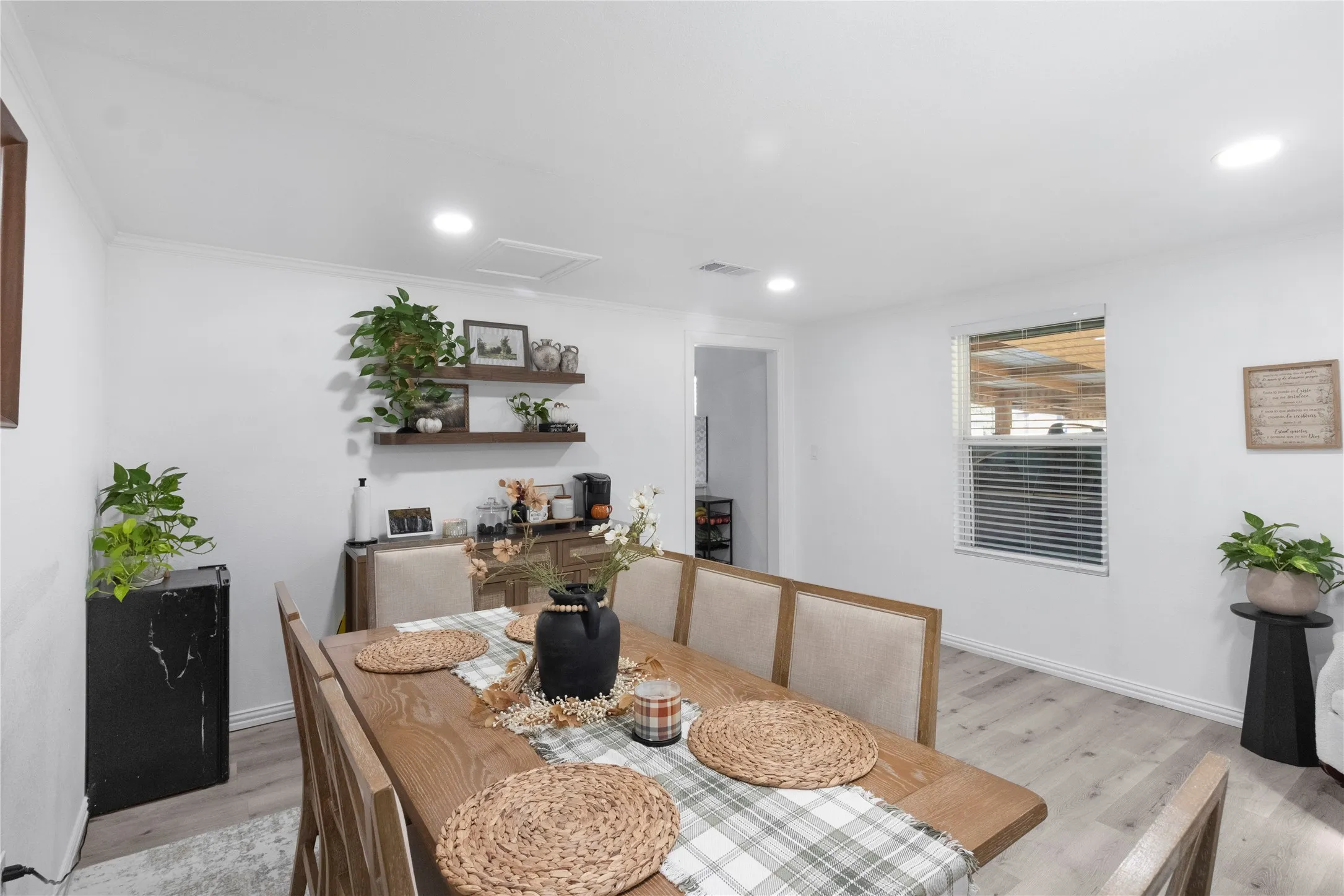 Recessed lighting, wood-finish flooring, white walls, and a window with horizontal blinds