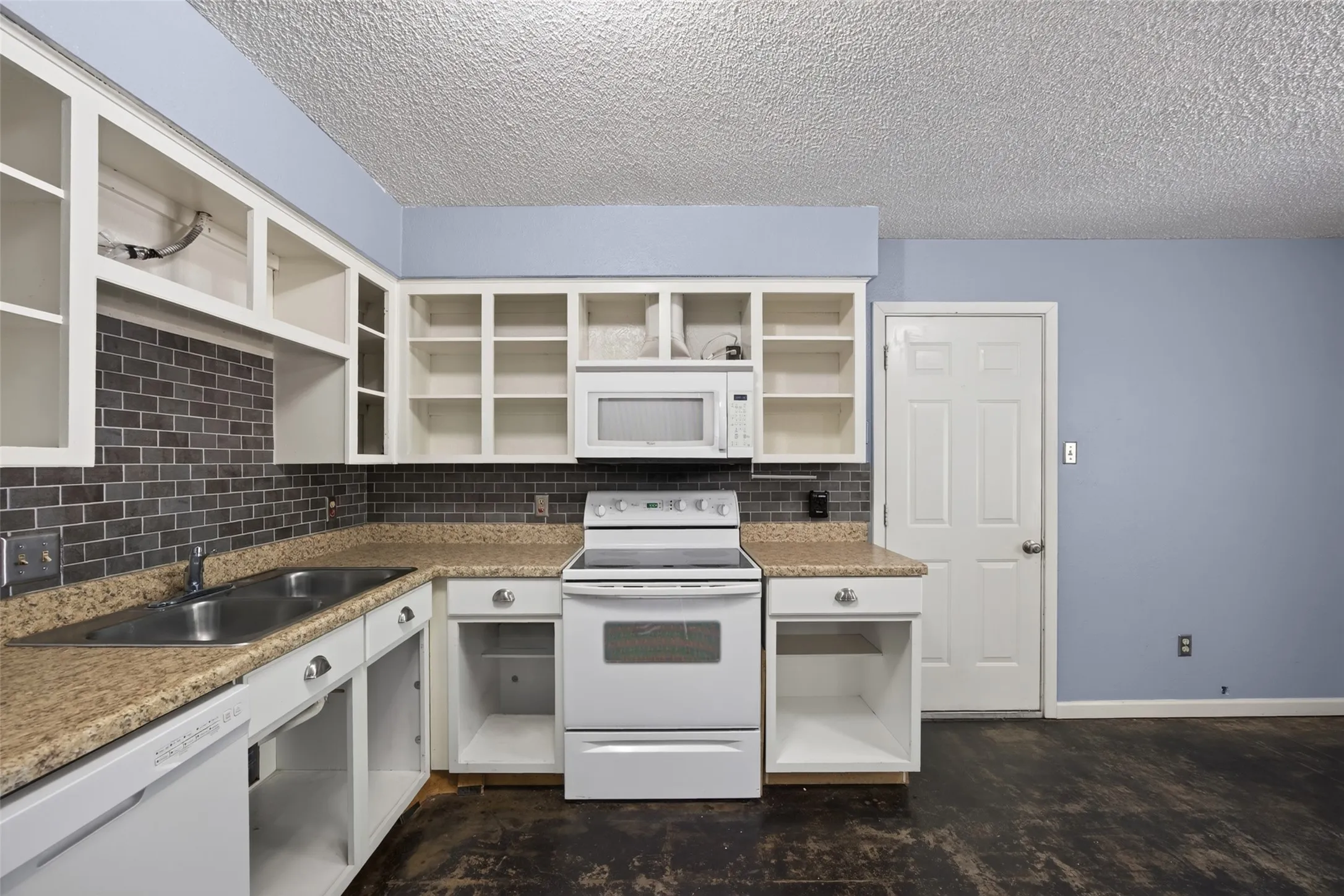 The kitchen cabinets have been made and you can either install them or keep them as open shelving
