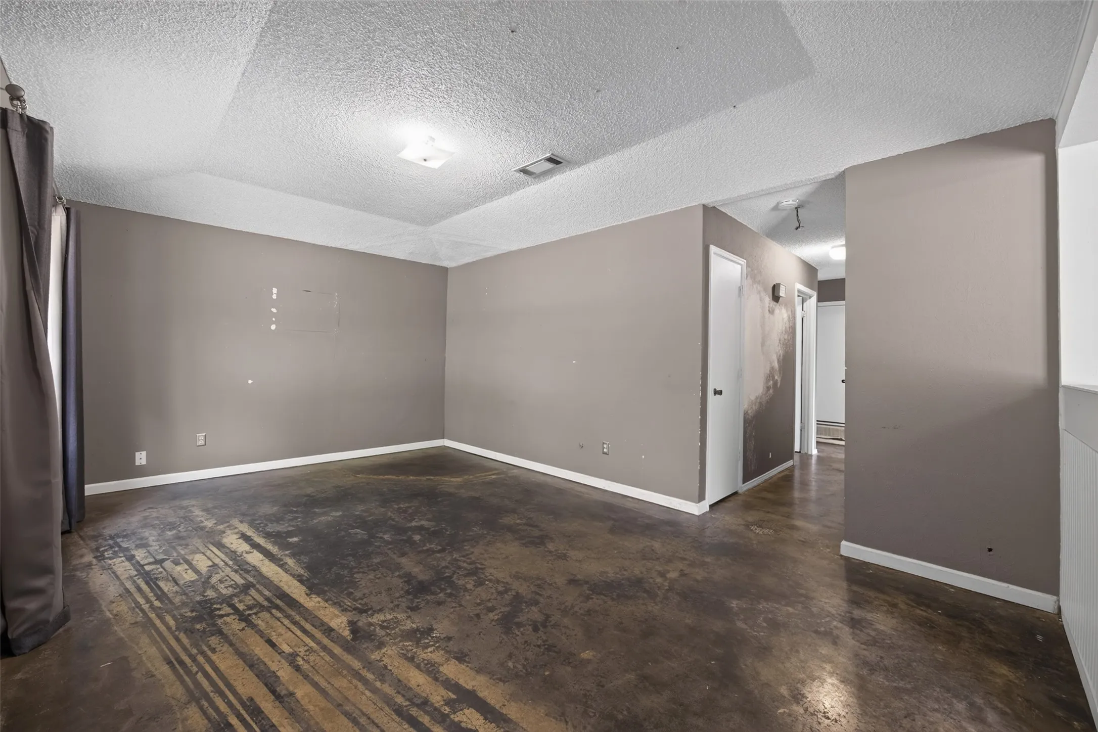 Large living room with stained concrete floors