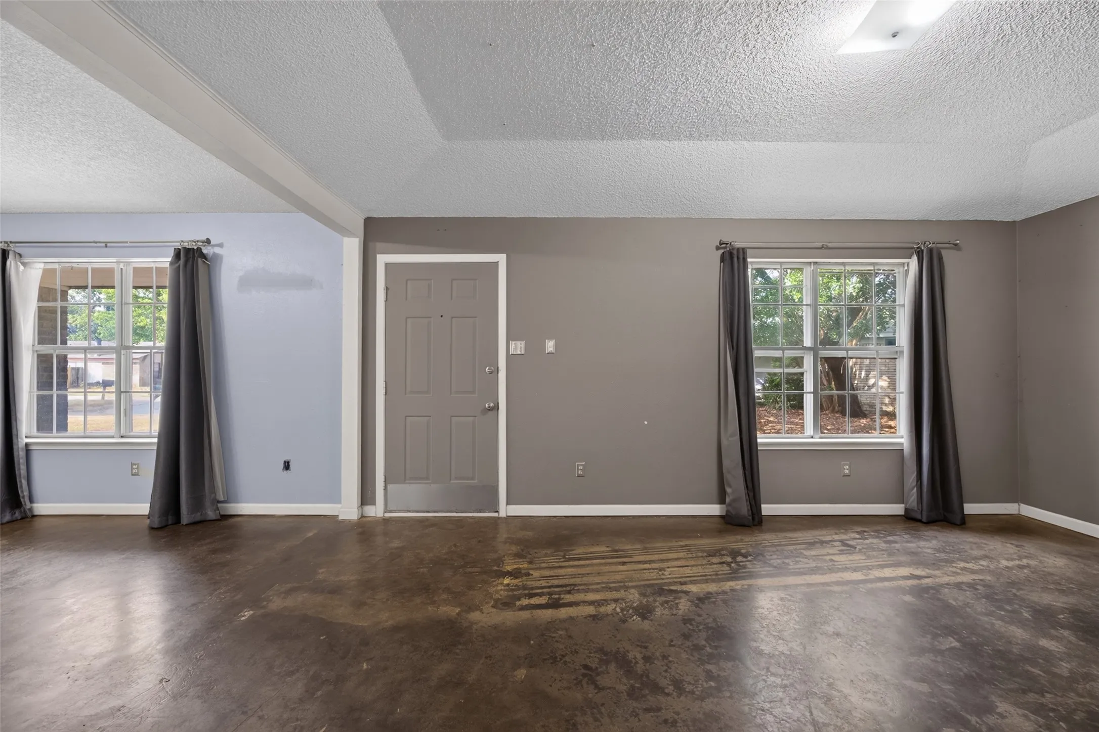 View of the front door with the living room on the right and the breakfast room on the left