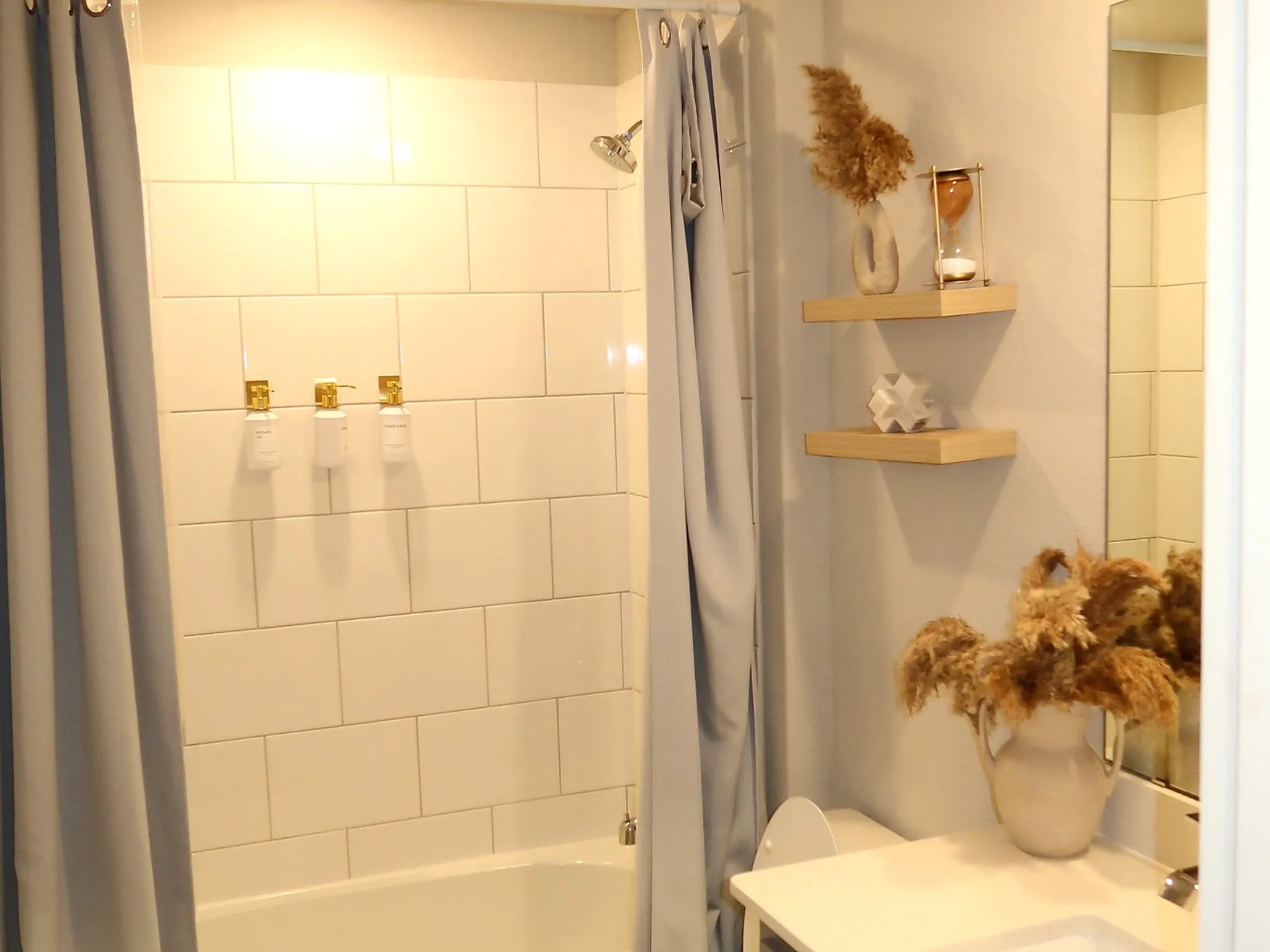 White subway tile shower surround with a chrome showerhead